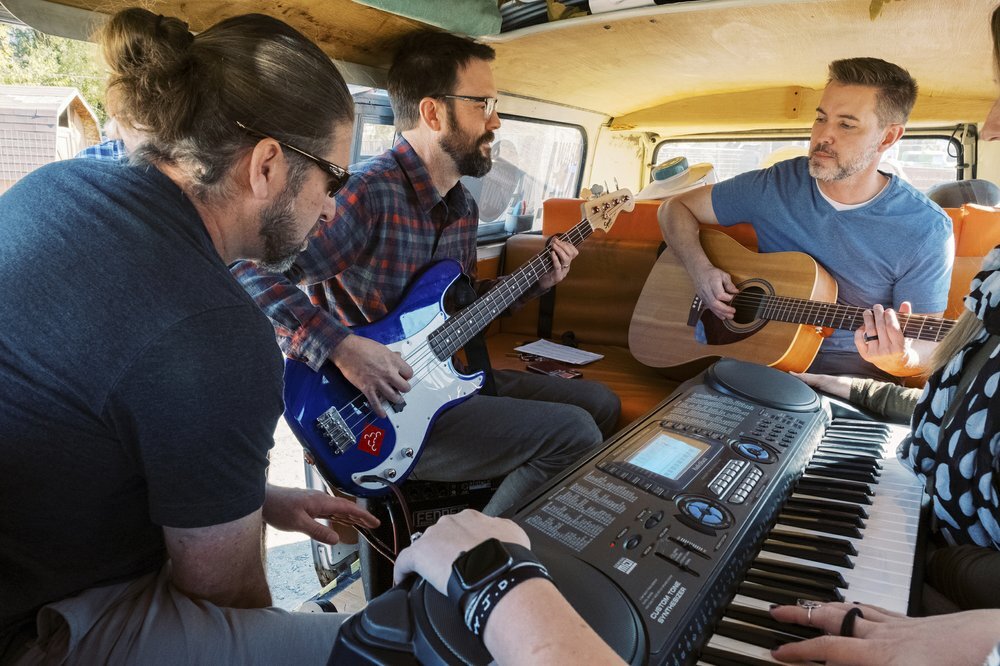 Corey Clayton, Griffin Dean, and Rick Sannar play in the van in the Hee Haw Farms parking lot on Saturday, Oct. 26, 2019, in American Fork, Utah. (Michael Schnell/The Daily Herald via AP)