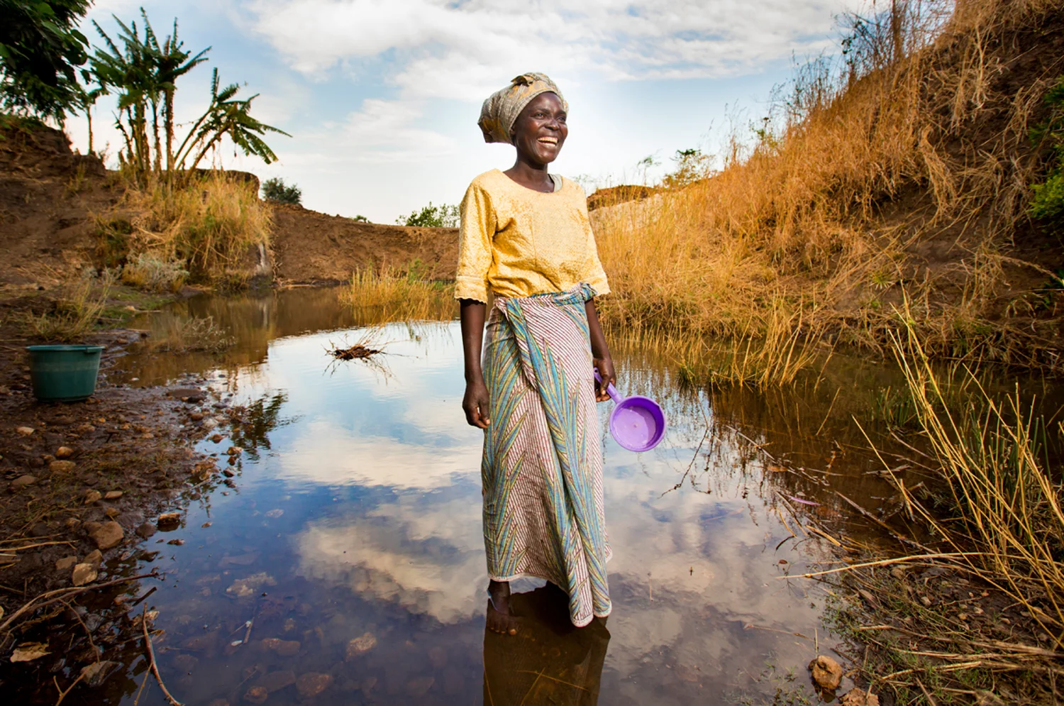 I camped in a village for a week and met a beautiful woman named Mulatani. She was vibrant and outgoing. She wanted to show me everything in her village. She loved her life and her friends — life each day was filled with walking to the local river for water for drinking, cooking and bathing. I followed her and got to know her deeper than I thought I would. We had a moment where she shared some very painful moments of her life and my translator and I both started to cry with her. We were so challenged by Mulitani’s wisdom and grace she had for others. She never thought she would see clean water in their village and I was standing with her the day the drilling rig hit the aquifer. I will never forget this moment. Her face lit up with excitement like I had never seen. She glowed as she stood watching water fly high into the air. 