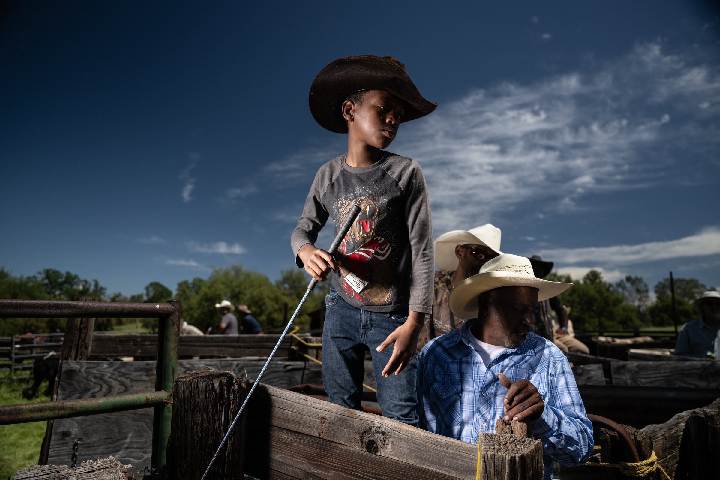 Young Black cowboy learning ranch traditions at The Lonesome E Cattle Company, Madera County California