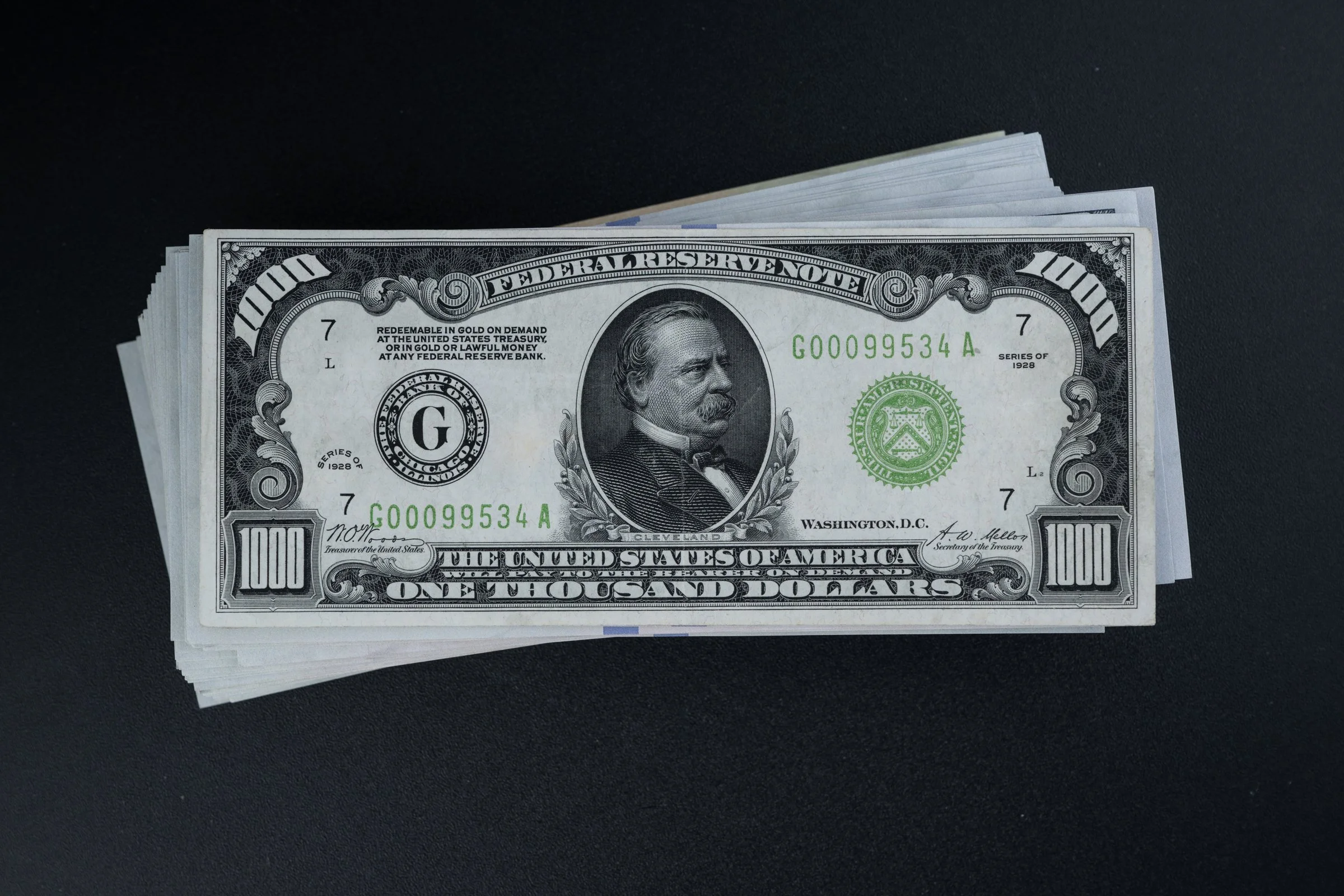 Stack of prop $100 bills used for positioning and lighting tests before photographing the actual rare currency