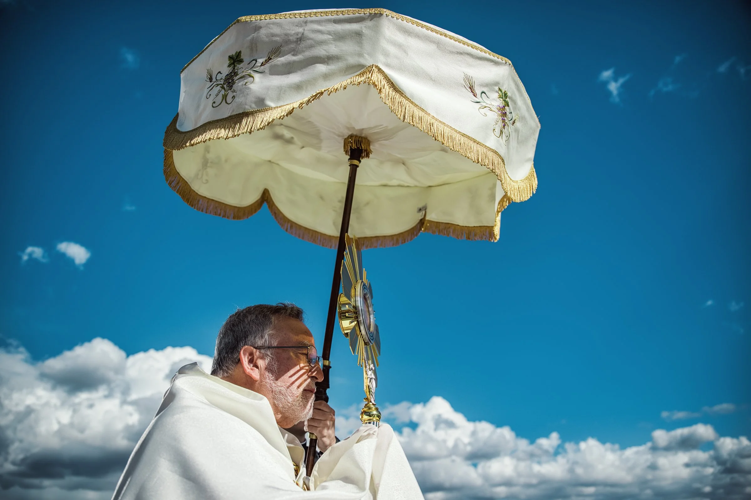 Bishop Soto leading Eucharistic procession on Lake Tahoe dock, documentary editorial photography Northern California