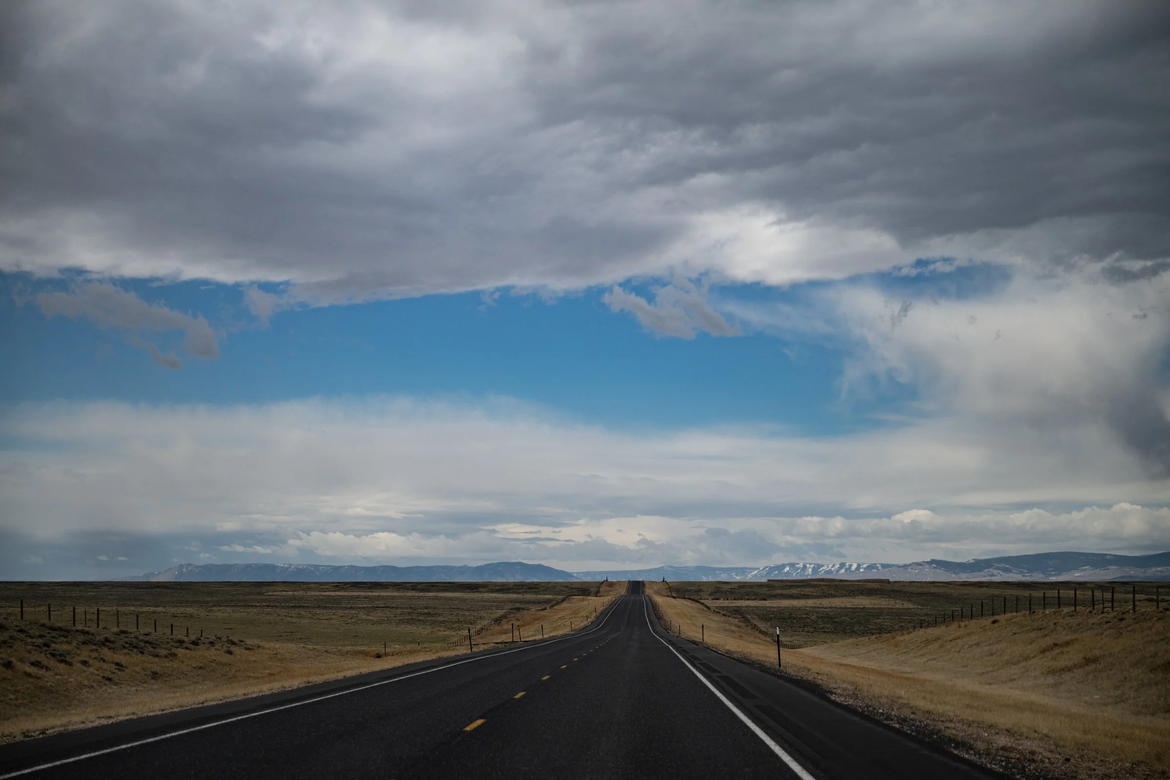 Open highway driving through Wyoming toward Camp Guernsey for Army ROTC field training exercise April 2025