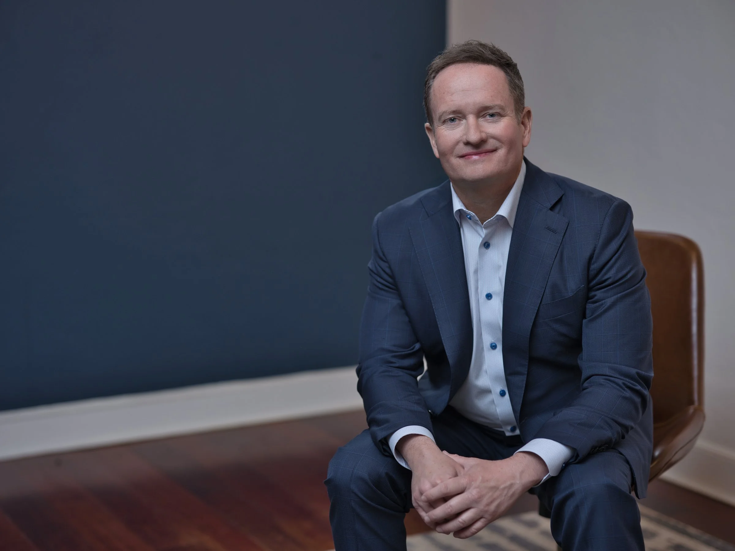 Men's corporate headshot in navy suit open collar, on-location professional portrait, Sacramento CA