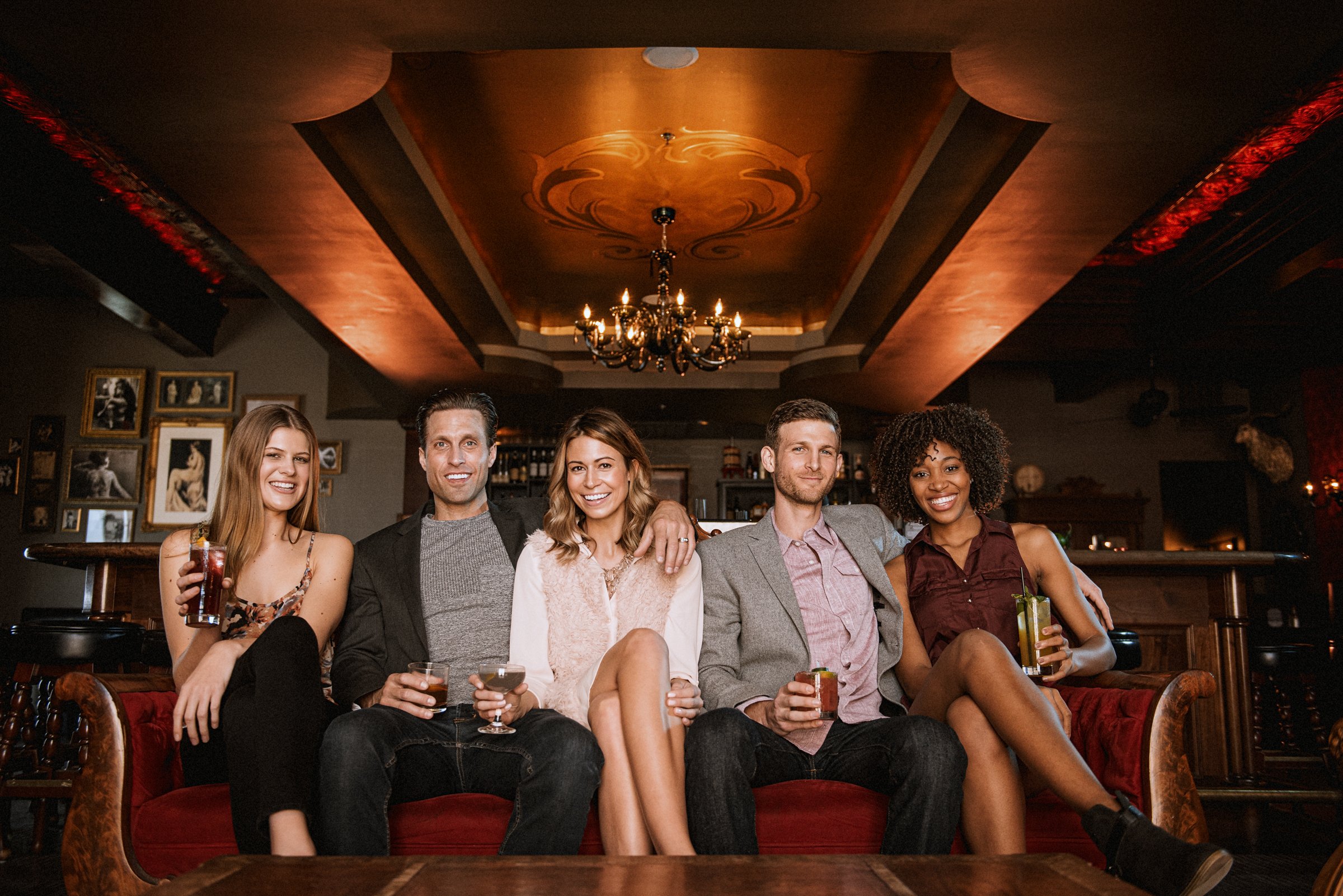 Group of friends socializing in upscale bar interior, hospitality lifestyle photography Sacramento