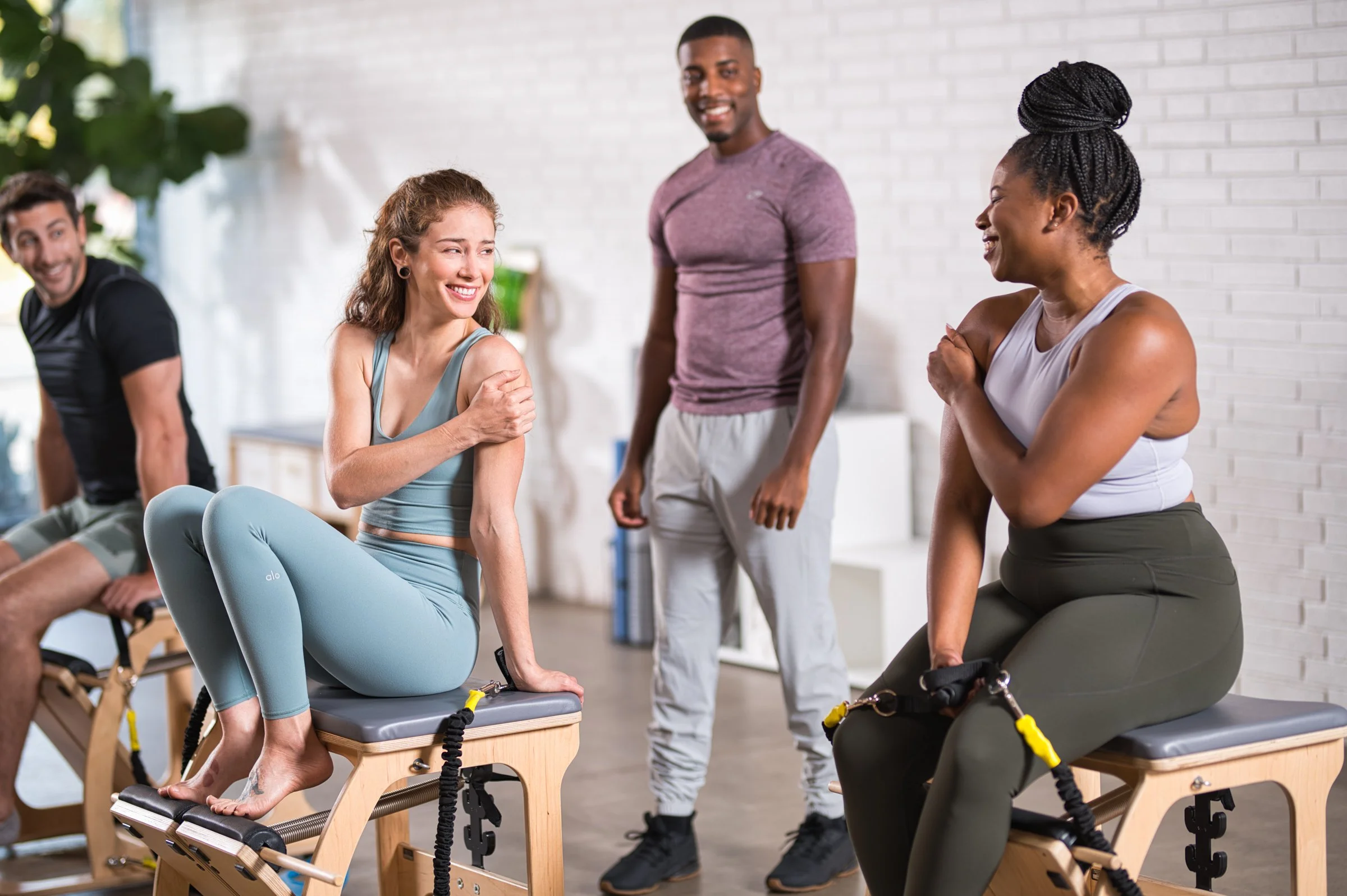 Fitness group with instructor in modern gym studio, commercial fitness photography Sacramento