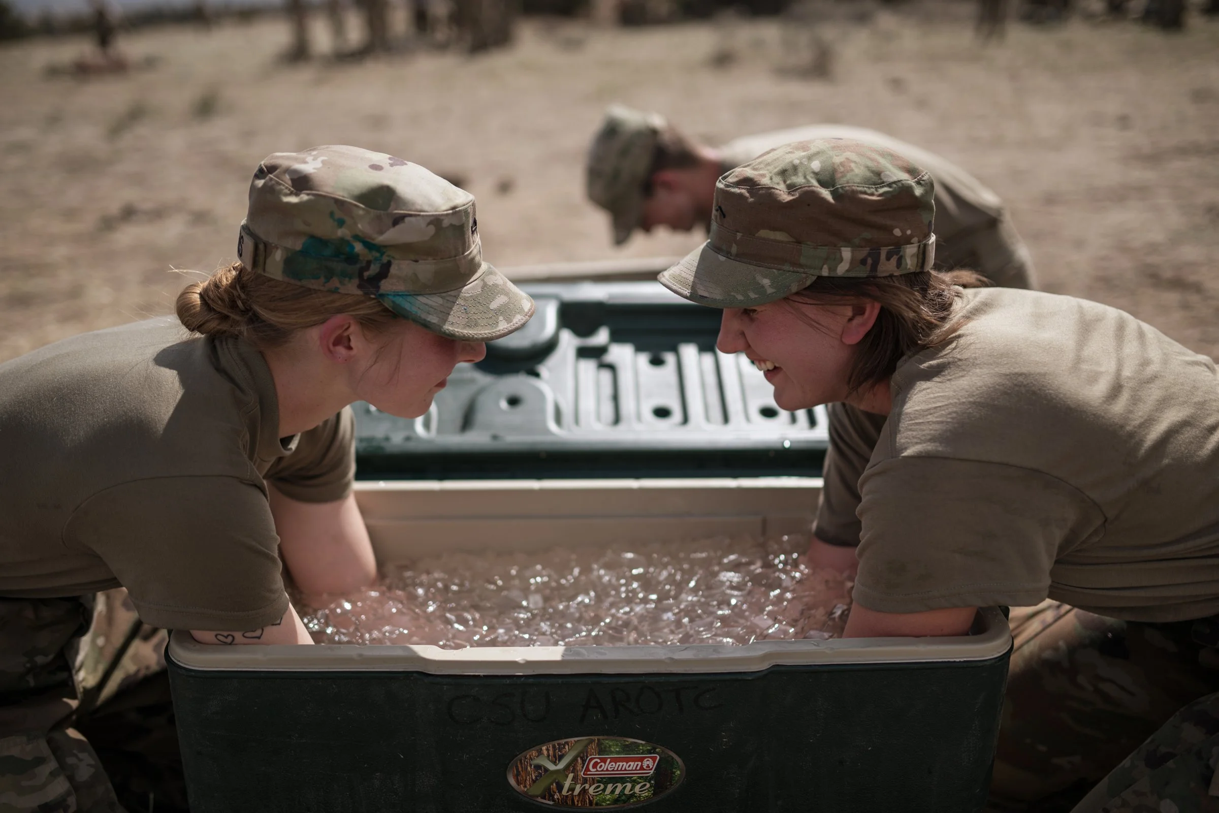 University of Wyoming Army ROTC female cadets cooling down at ice cooler during field training exercise Camp Guernsey April 2025