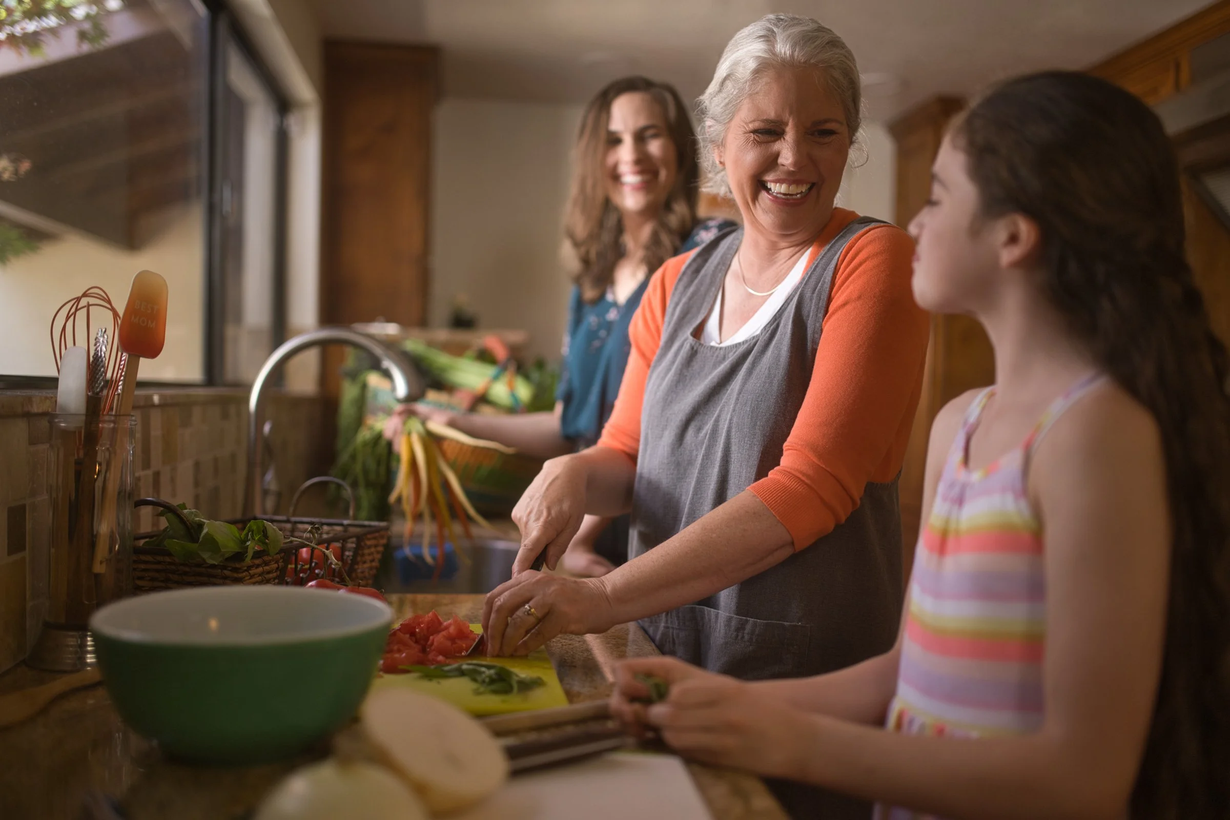 Grandmother and granddaughter cooking together in kitchen, lifestyle brand photography