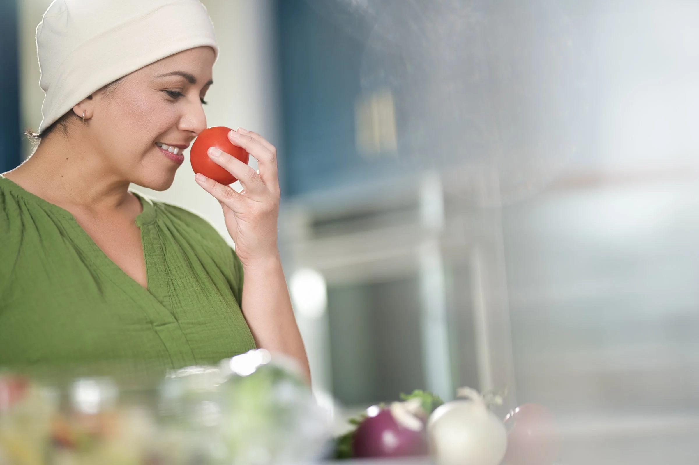 Woman in head wrap eating fresh apple, health and wellness lifestyle photography