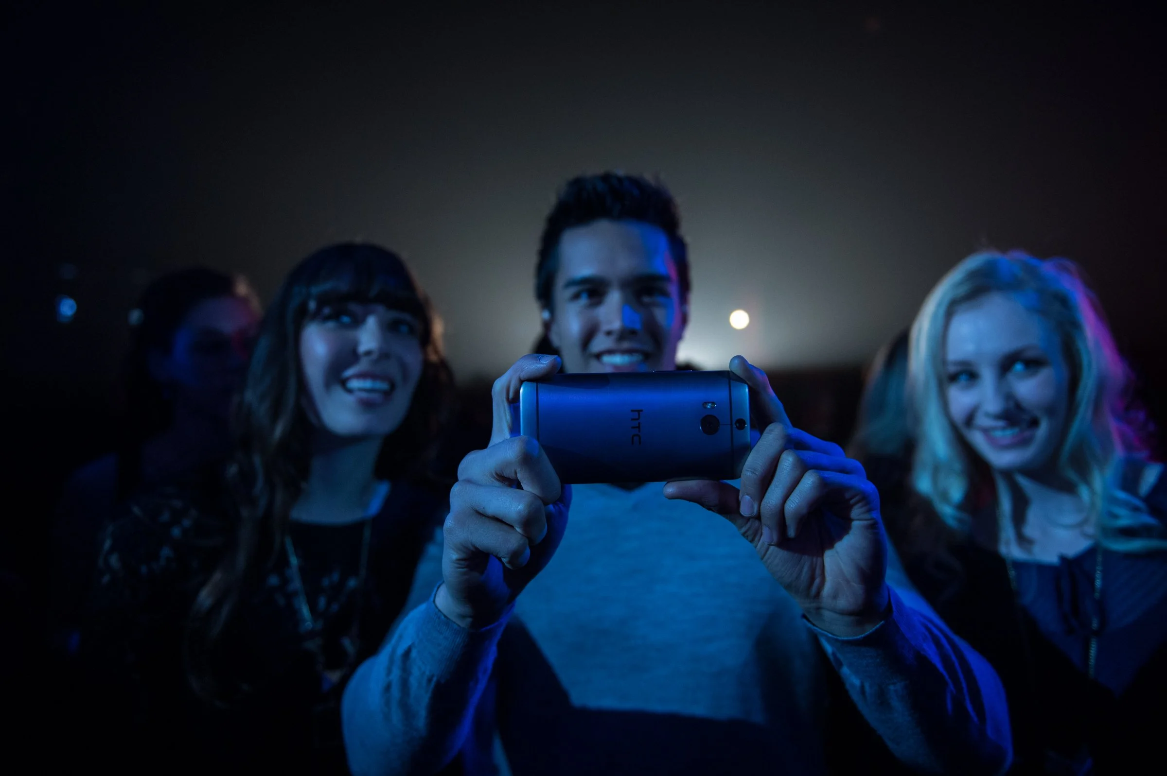 Couple at concert venue with blue stage lighting, entertainment and events photography Sacramento