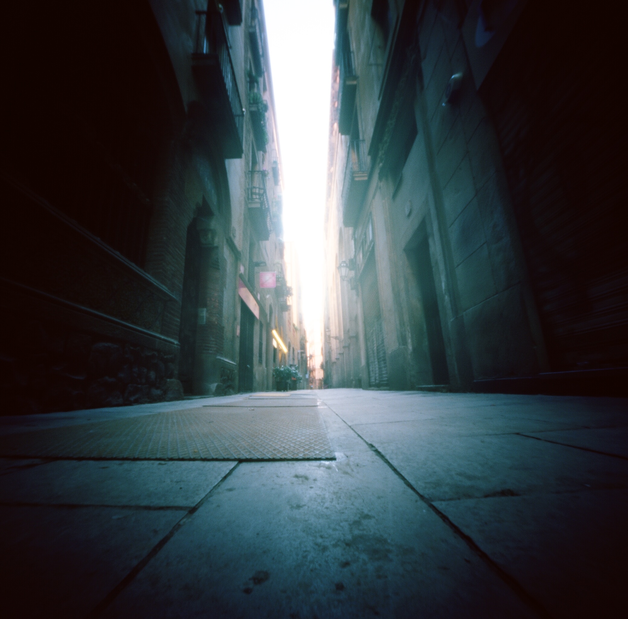 This image was made on Pinhole Day as we strolled through the streets. I had my ONDU 6x6 on the floor and pointed up. It captures just one of the many long, narrow streets of Barcelona.