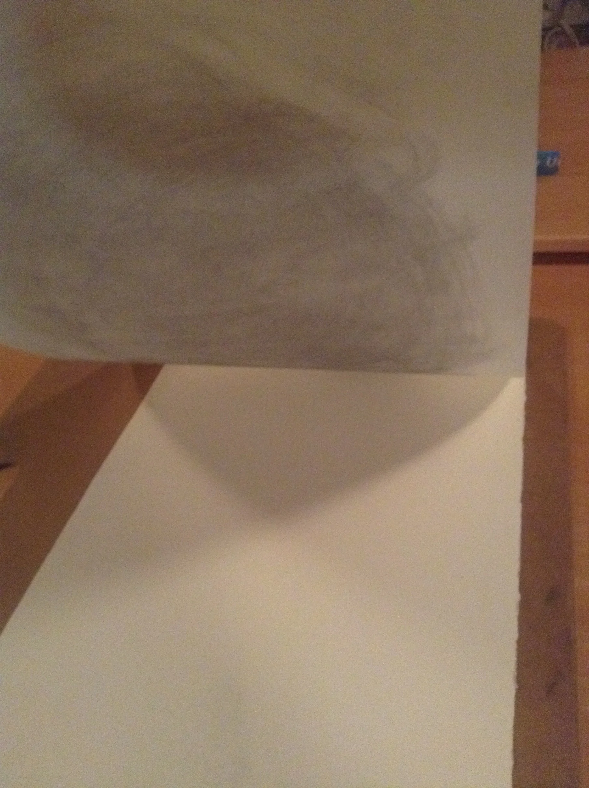 2) Place the original drawing over the new piece of paper. Be very careful to line them up exactly, so the drawing isn't transferred at an angle. I used the side of my drawing board to make sure the paper and drawing were parallel.
