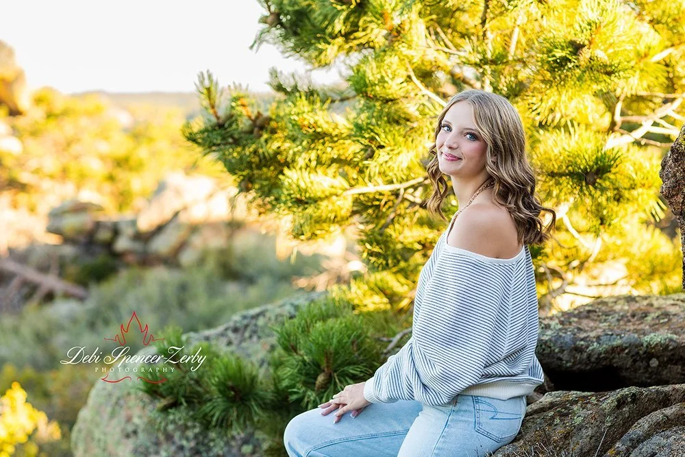 Senior in a natural setting with greenery and open space.