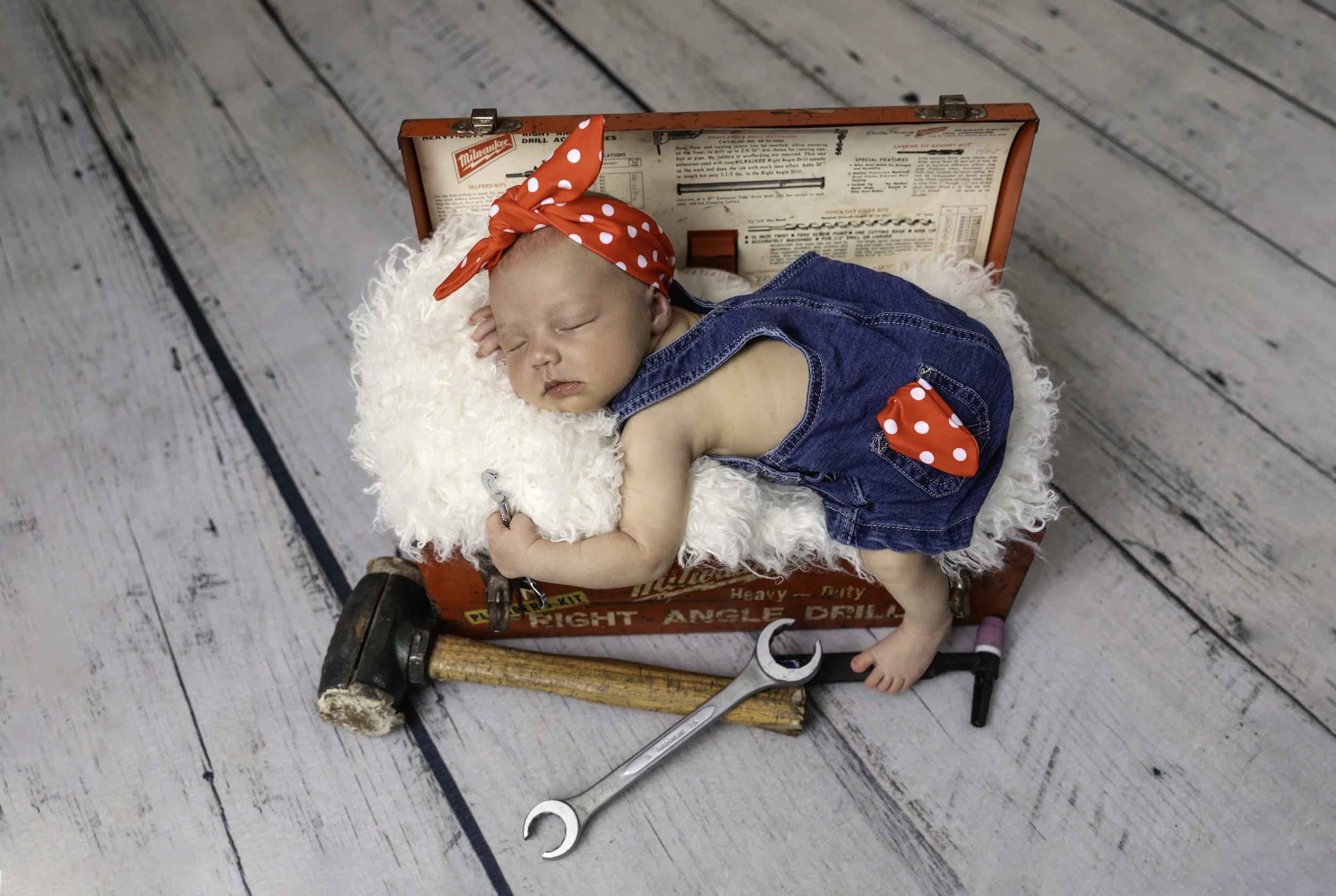 Newborn baby girl in studio in a prop
