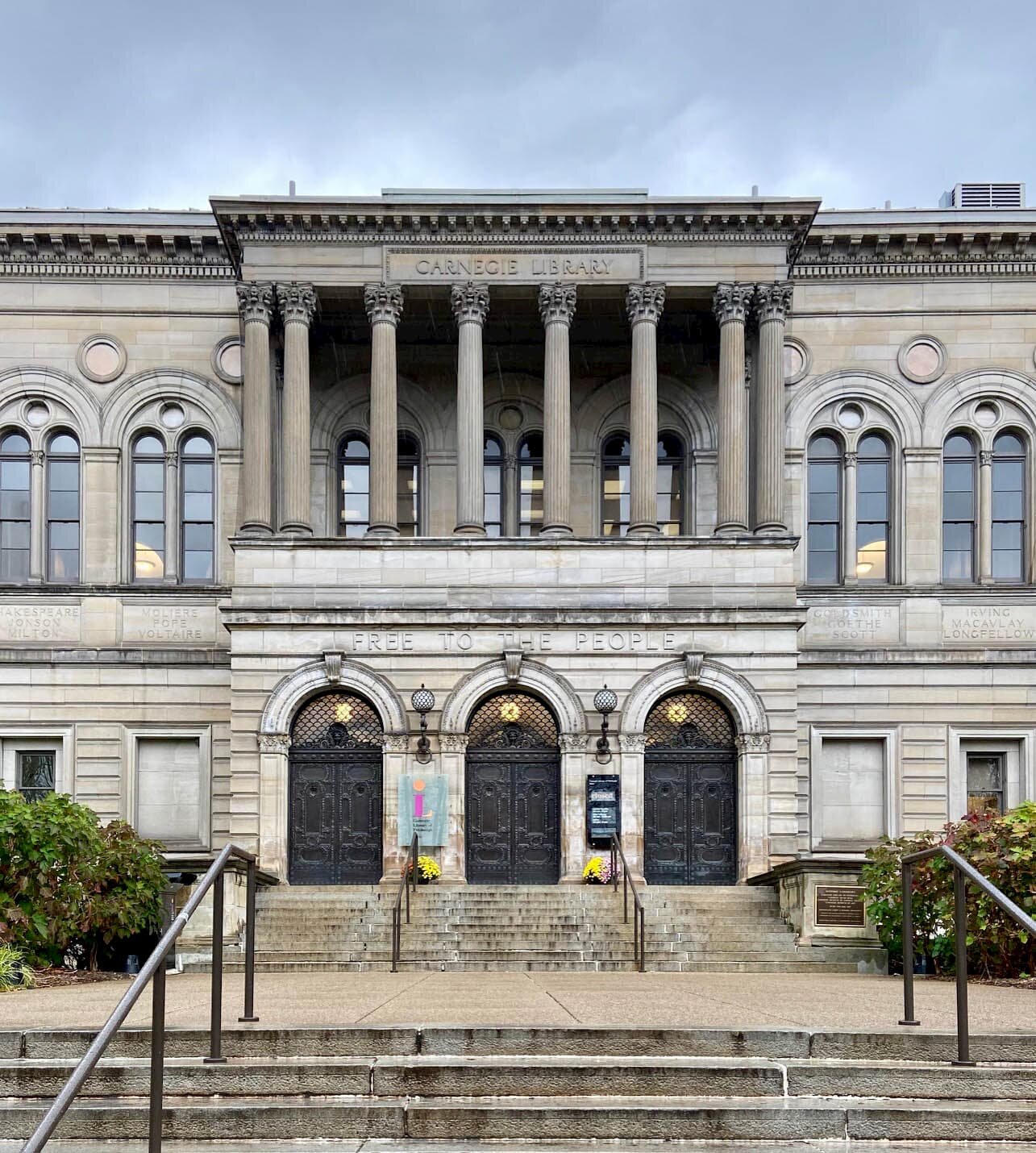  The entrance to the main Carnegie Library in Pittsburgh. The words “Free to the People” are carved into the stone above the three massive entry doors. 