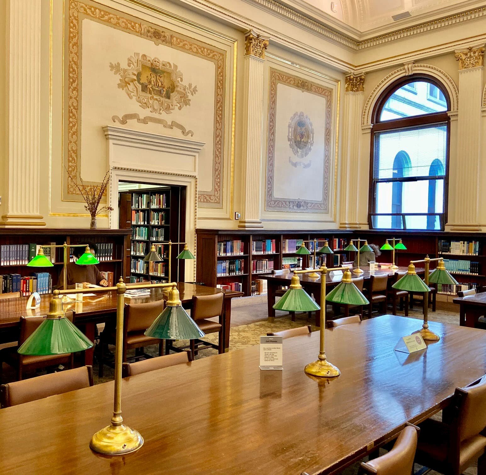  The library’s reading room has kept many original features, including wall frescoes and furniture. 