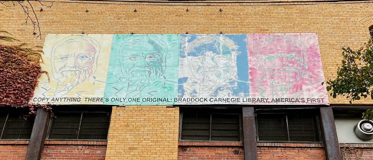  A banner depicting Andrew Carnegie on the library’s wall, designed in the style of Andy Warhol’s silkscreen prints. The text reads: “Copy anything, there’s only one original: Braddock Carnegie Library, America’s first”. 