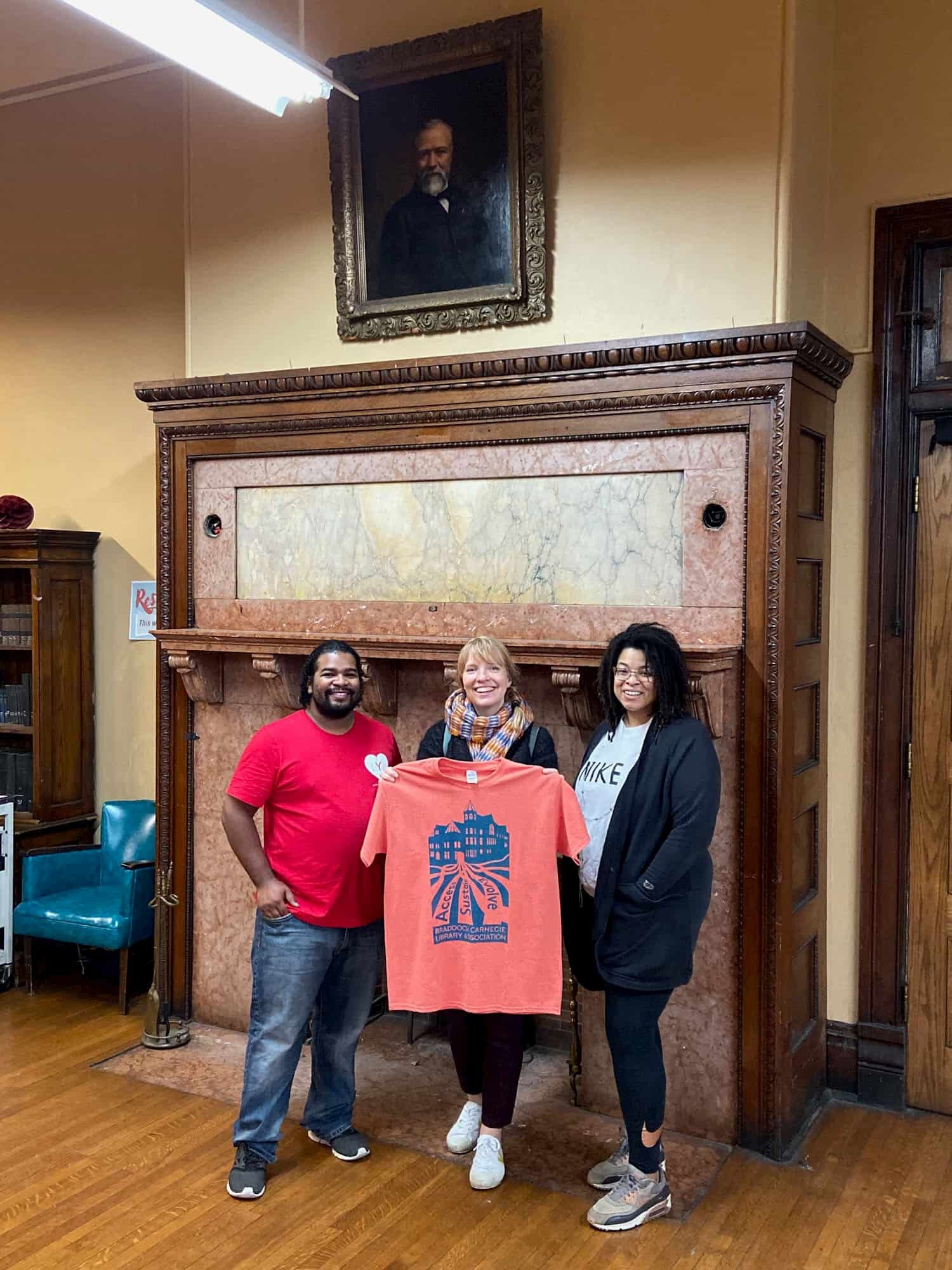 Our Curator with two members of the Braddock library staff, standing under the watchful eye of Andrew Carnegie. 