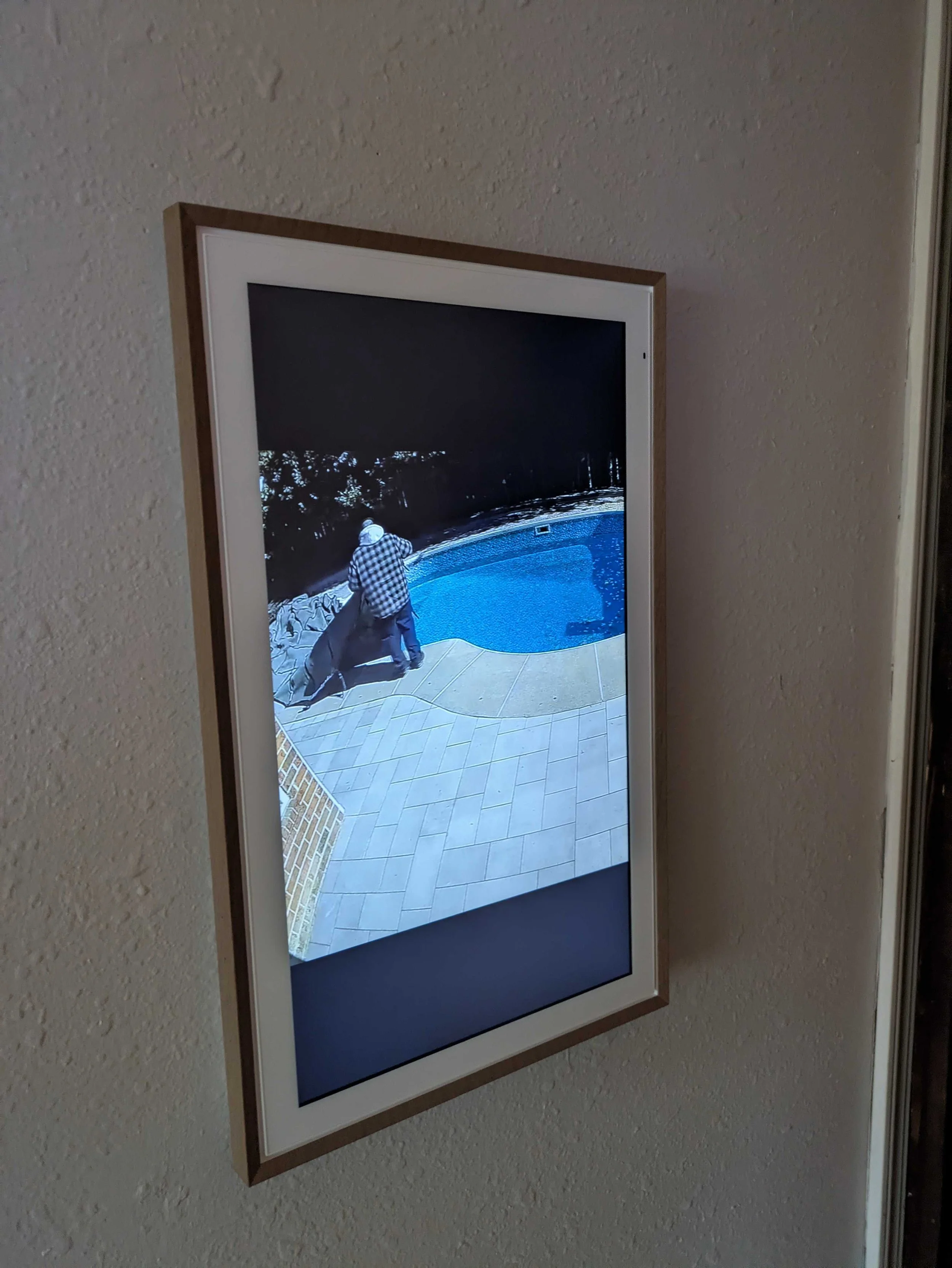 Just Gavin working near the pool open a nicely installed wall TV