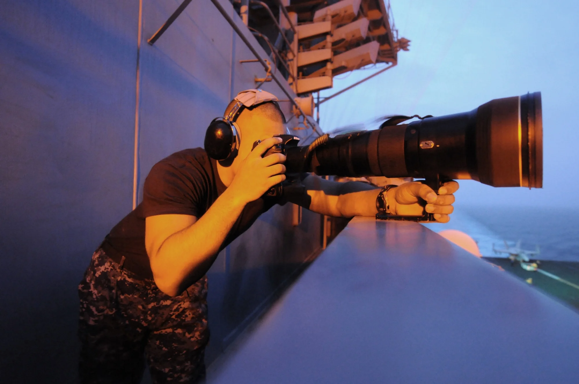 US_Navy_110724-N-WH671-103_Mass_Communication_Specialist_Seaman_Apprentice_Brian_M._Read_Castillo_takes_intelligence_photographs_aboard_USS_George.jpg