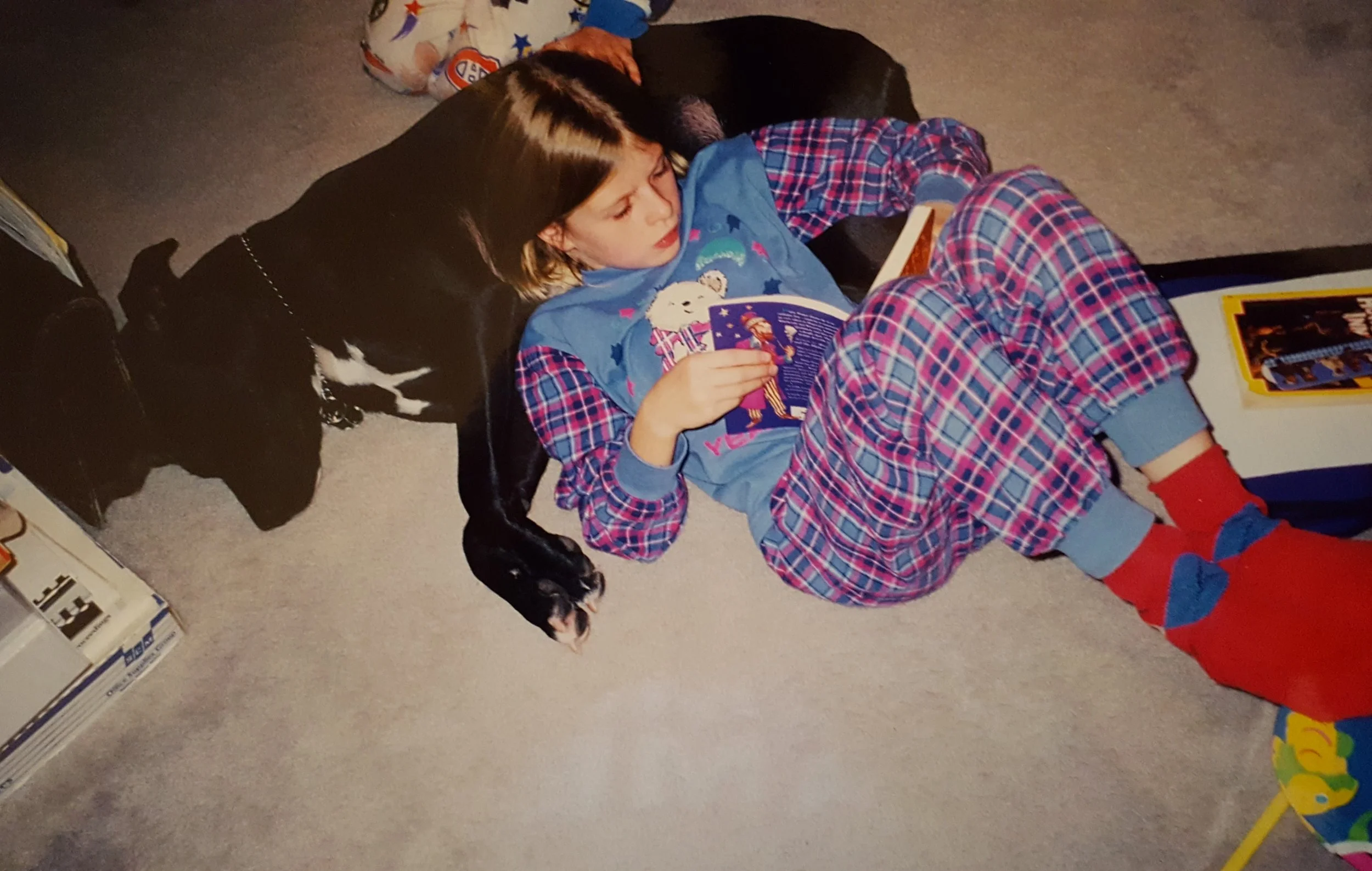 Circa 1999. Yes, I'm reading Harry Potter. Yes, my dog is my pillow. And yes, I know my socks don't match my pyjamas.