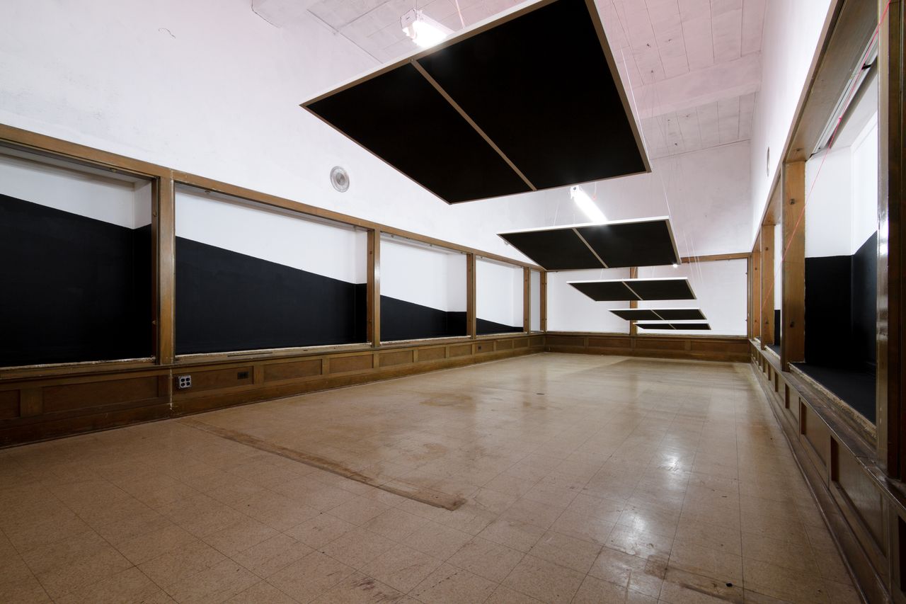 Untitled SCHAUM/SHIEH In this installation, panels are hung from the ceiling to extend and suggest a floating wedge of space. The panels strike a diagonal plane in the room, placed within the rhythm established by the recessed display cases of this former museum. An orthogonal field of point lights illuminate the colored panels, to produce a varying glow within the space. Working with minimal elements, the installation is an experiment in transforming the existing space subtly, simply, and atmospherically. Rosalyne Shieh is an architect and partner at SCHAUM/SHIEH. She is also Assistant Professor of Architecture at the University of Michigan, where she was the 2009-2010 Taubman Fellow in Architecture. She received her Master of Architecture from Princeton University, a BA in Architecture from the University of California, Berkeley, and an MSc in Architectural History and Theory from the Bartlett School of Architecture in London. She has taught at NJIT and worked in the offices of Abalos & Herreros in Madrid, and ARO and Stan Allen Architect in New York City. Troy Schaum is an architect and an Assistant Professor at Rice School of Architecture, where he was the 2008-2009 Wortham Fellow. He received his Master of Architecture from Princeton University and Bachelor of Architecture from Virginia Tech. In 2008 he co-founded SCHAUM/SHIEH Architects, a studio focused on testing new possibilities for form, representation and politics in the post-megalopolitan city. With his firm, Schaum has recently completed designs for a range of projects including, an art center in Dublin, pop-music center in Taiwan and an alternative urban plan for a shrinking Detroit.