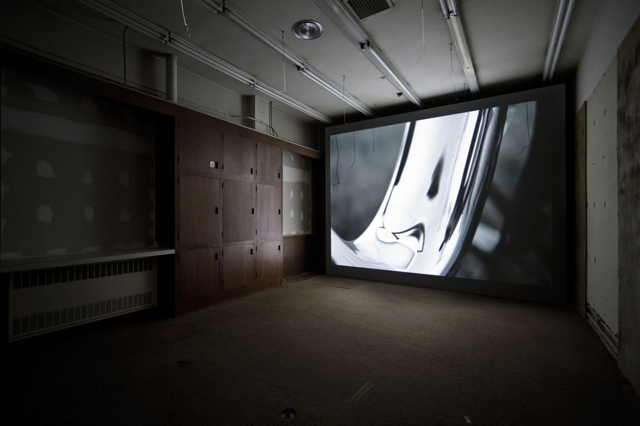 Displace Displace Displace is a study in material and optical distortions as captured in mirrored glass. The work is comprised of a physical installation in the historical Calkins Law Office, and the paired film Semblance on view inside 54 Jefferson. The work seeks to create a peculiar occupation of the space, while also presenting, in reflection, the further existence of the space through distortion, multiplicity, scale, and displacement. Symmetries, patterns, and realities are disrupted. Displace have been generously funded by the Taubman College of Architecture and Urban Planning Research Through Making Grant. Catie Newell is an Assistant Professor of Architecture at the University of Michigan and founding principal of *Alibi Studio, Detroit. Newell’s work and research captures spaces and material effects, focusing on the development of atmospheres through the exploration of textures, volumes, and the effects of light or lack thereof. The work often reconfigures existing domestic spaces. Newell’s creative practice has been widely recognized for exploring design construction and materiality in relationship to location and geography, and cultural contingencies. Newell’s Salvaged Landscape won the 2011 ArtPrize juried Urban Space award. Grant Weaver is a designer and filmmaker, currently working with *Alibi Studio in Detroit. He holds a Master of Architecture and a Bachelor of Science from the University of Michigan with high distinction. He also holds an Associate of Science and Arts from Northwestern Michigan College. Weaver has collaborated on numerous research projects culminating in full scale installations, exhibited in galleries such as the Parsons New School Gallery, NY, the Extension Gallery, Chicago, and most recently the Venice Architectural Biennale in Venice Italy. Weaver’s current research is focused on material systems and their behavior, often explored through the peculiarities of a site. As a body of ongoing research, these investigations seek to create an interactive dialogue between the architecture, occupant, and environment. Wes Mcgee is the Director of the FABLab at the University of Michigan Taubman College of Architecture and Urban Planning and a principal at Matter Design Studio, which he founded with Brandon Clifford in 2008. He also holds a lecturer position in the College where he teaches courses in robotic fabrication, and conducts research on advanced fabrication methodologies. The primary focus of the FABLab is to develop innovative fabrication workflows for architecture. His recent work includes an installation at the OSU Knowlton School of Architecture entitled La Voute Lefevre, which was published in Monitor Vol 68, and a large scale robotically fabricated steel structure in the Australian Pavilion at the 2012 Venice Architecture Biennale.