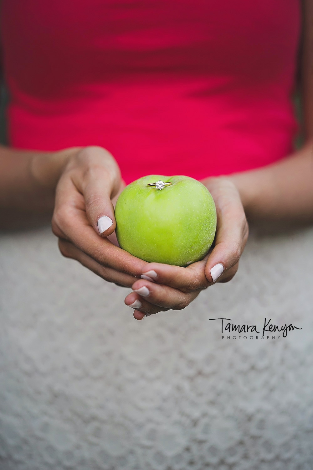 engagement ring on an apple