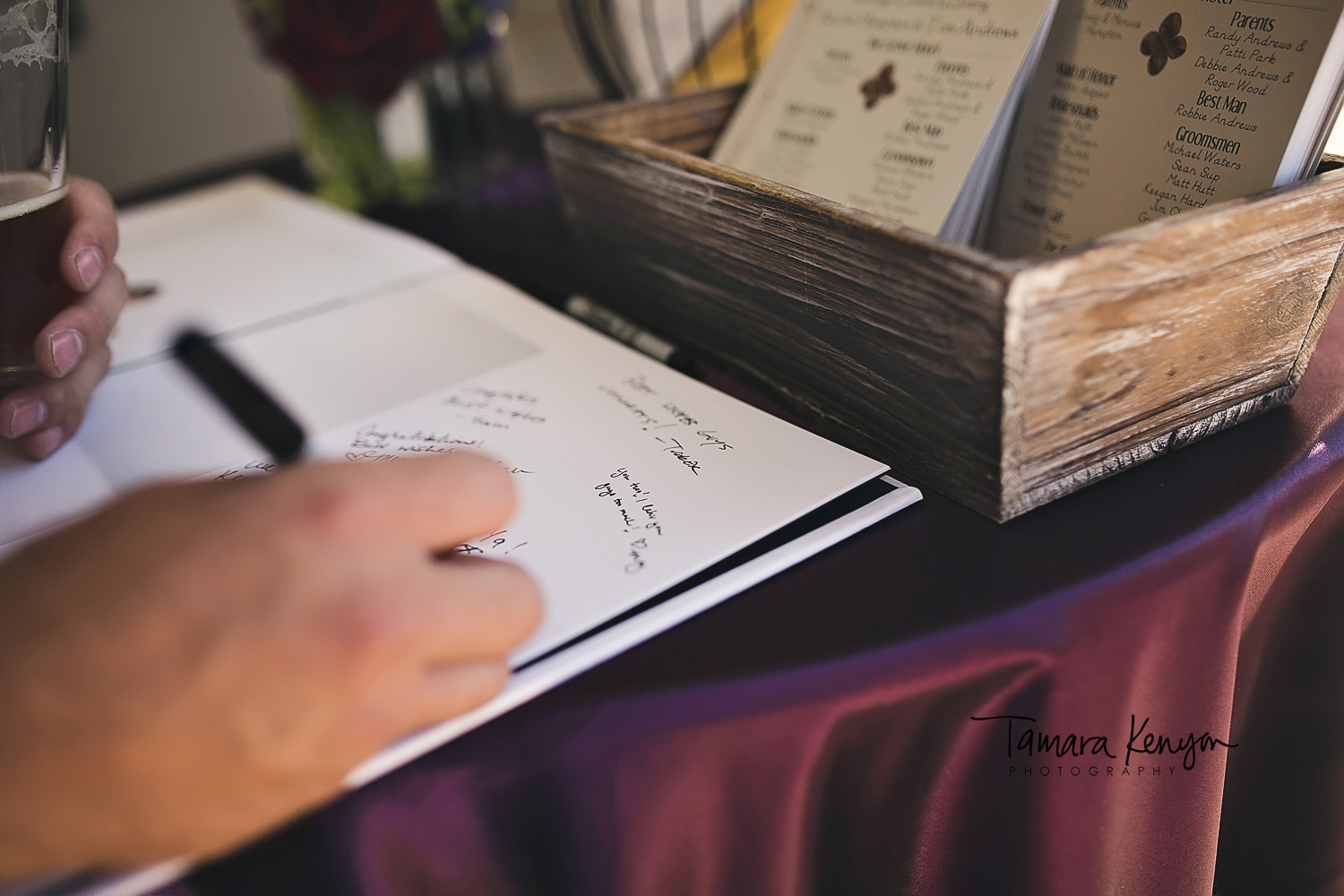 wedding guests signing guestbook