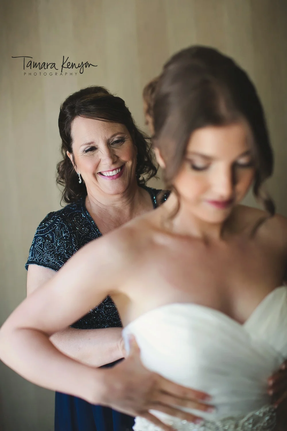 bride getting ready with mother
