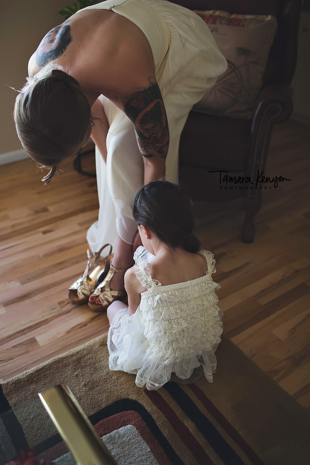 flower girl helping bride with her shoes