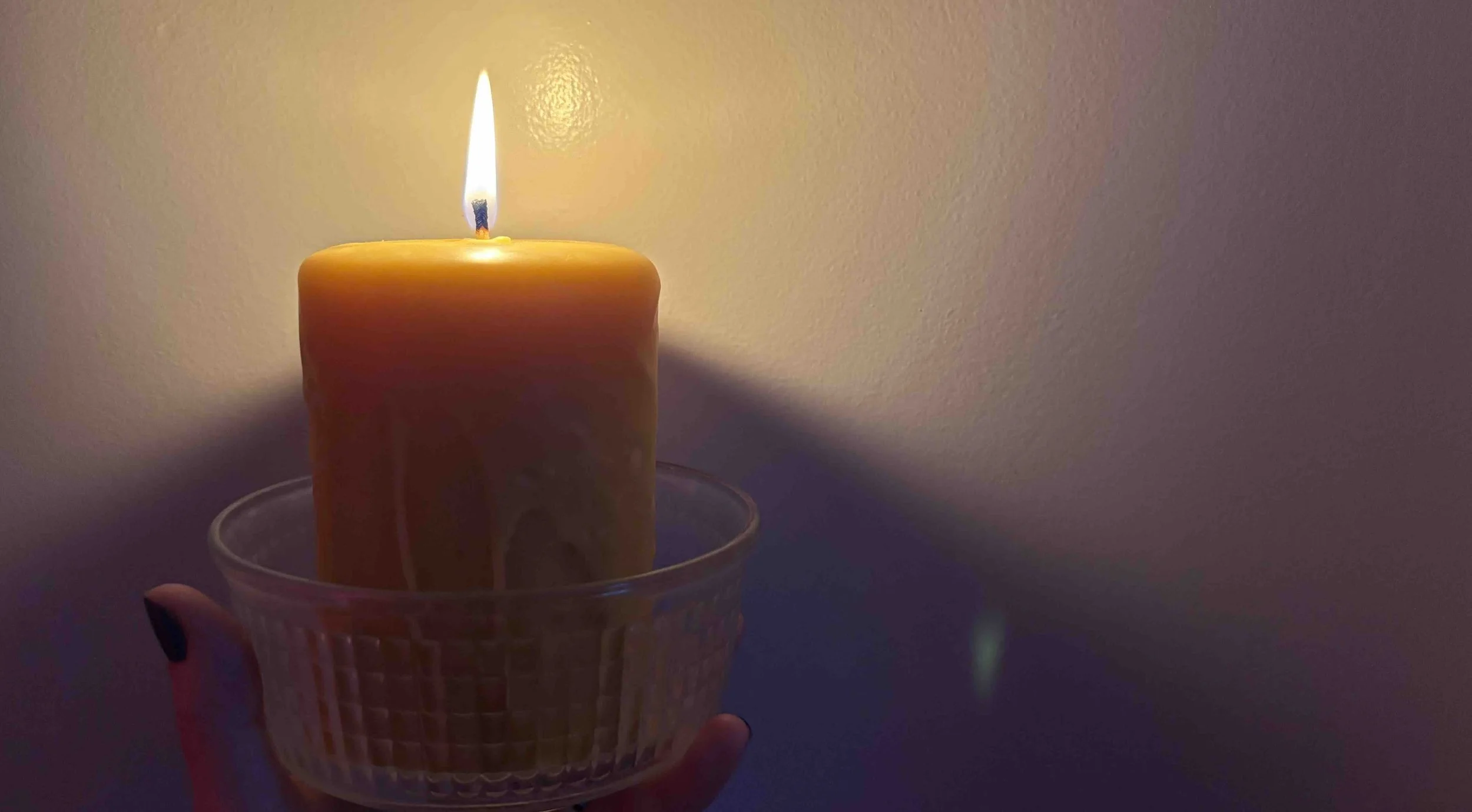 Glowing yellow candle to light the way to your creative life