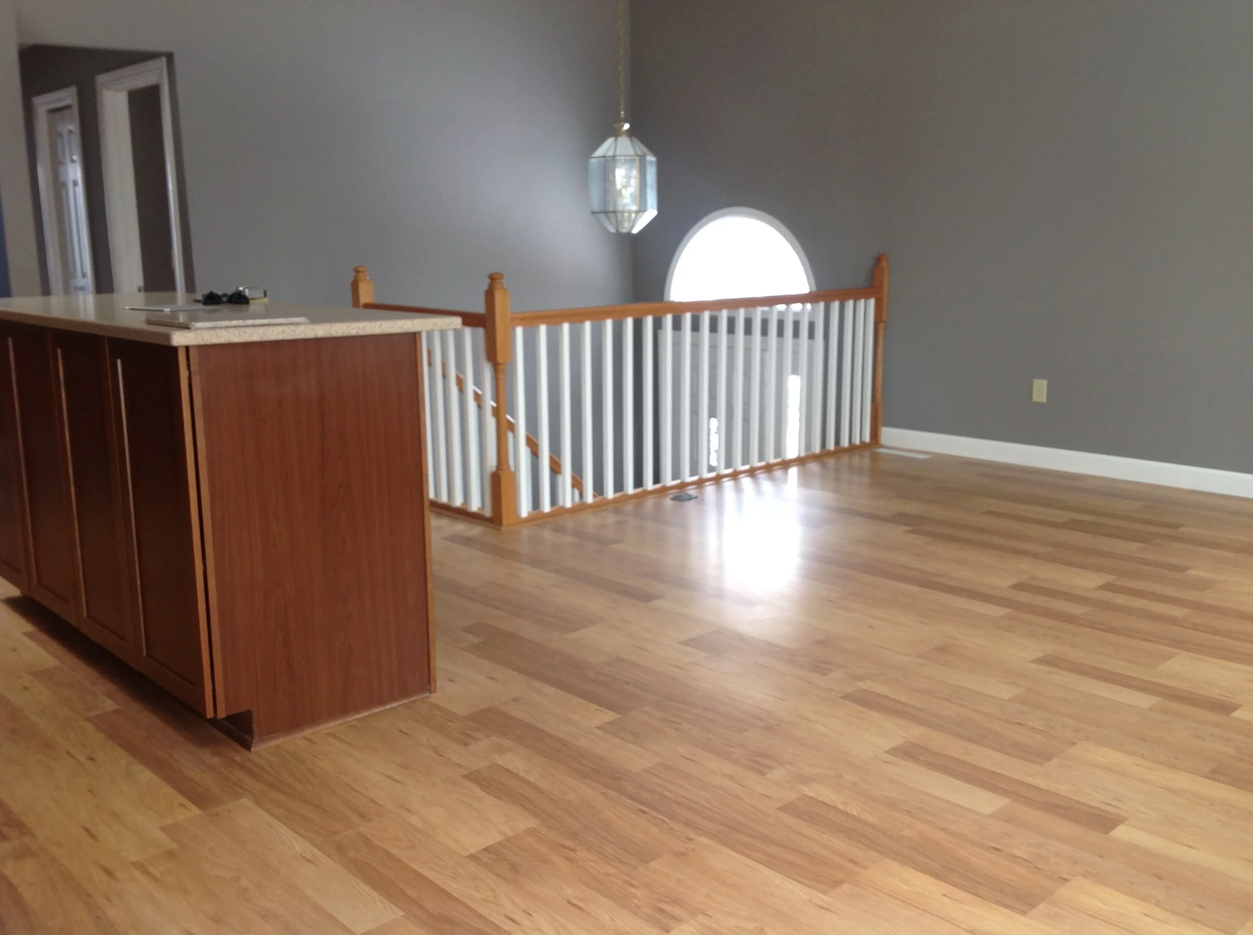  Open floor plan with wood floor and new windows. 