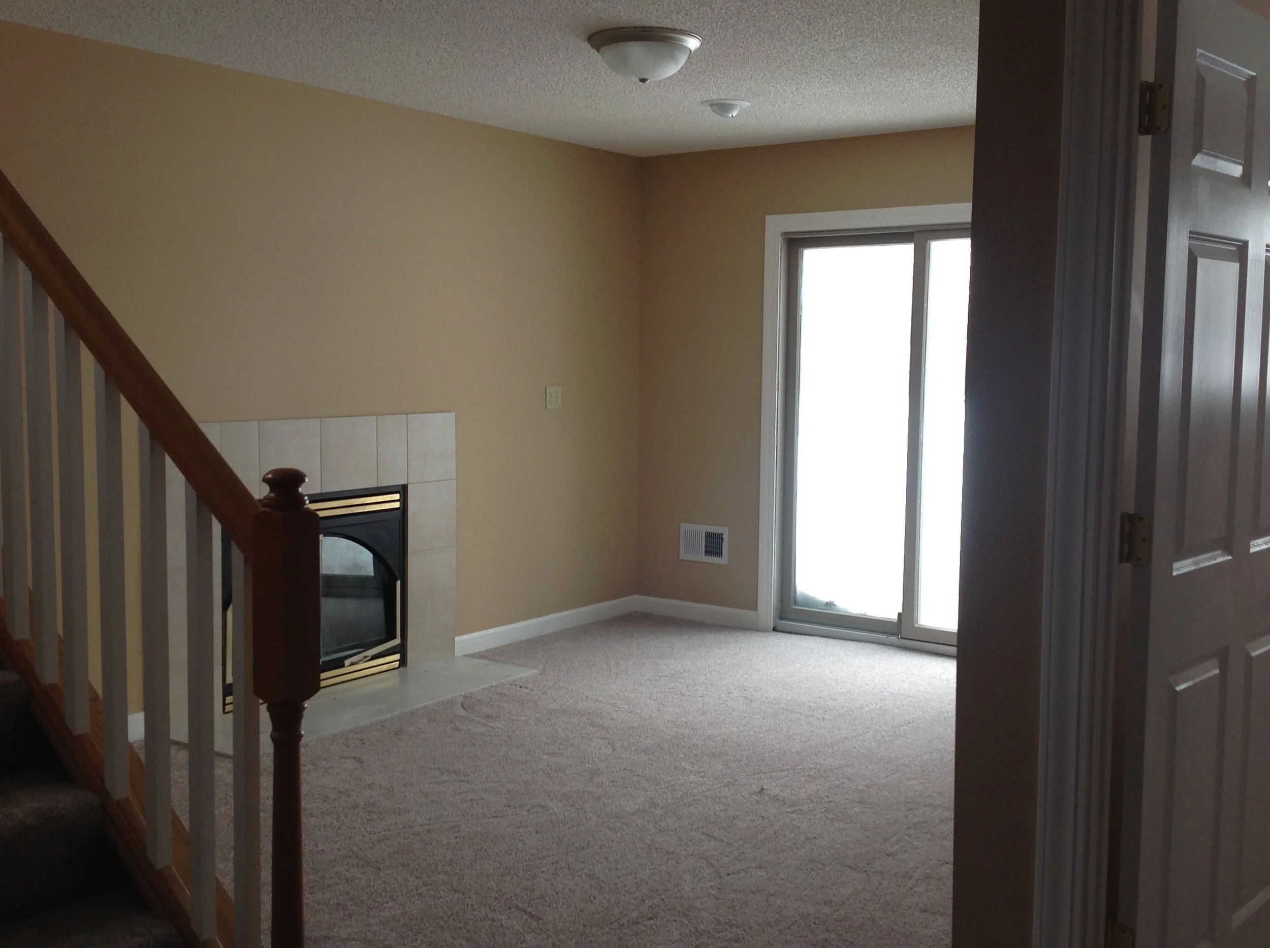  Downstairs family room with wood-burning fireplace. 
