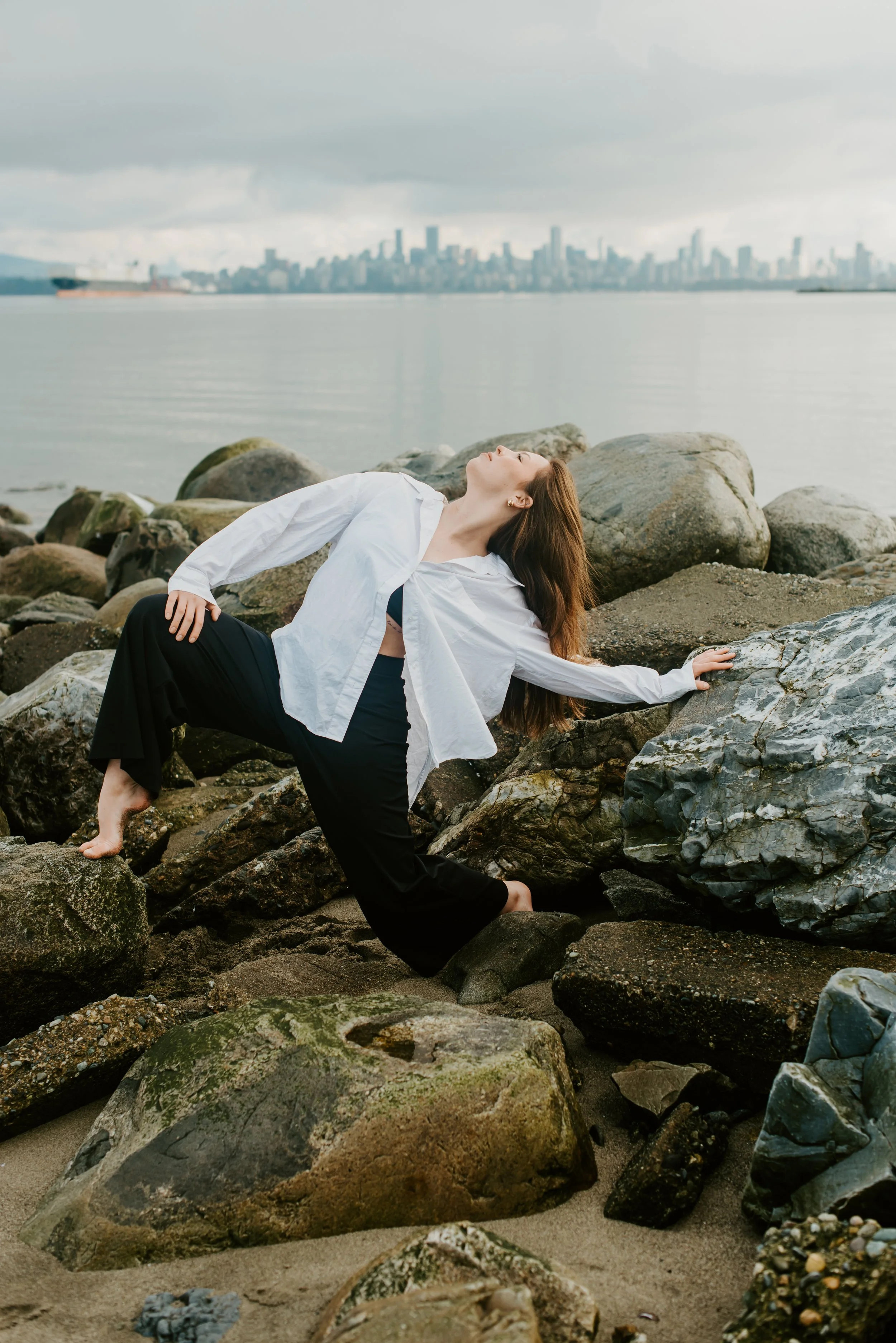 dancer-lunging-surrounded-rocks-ocean.jpg