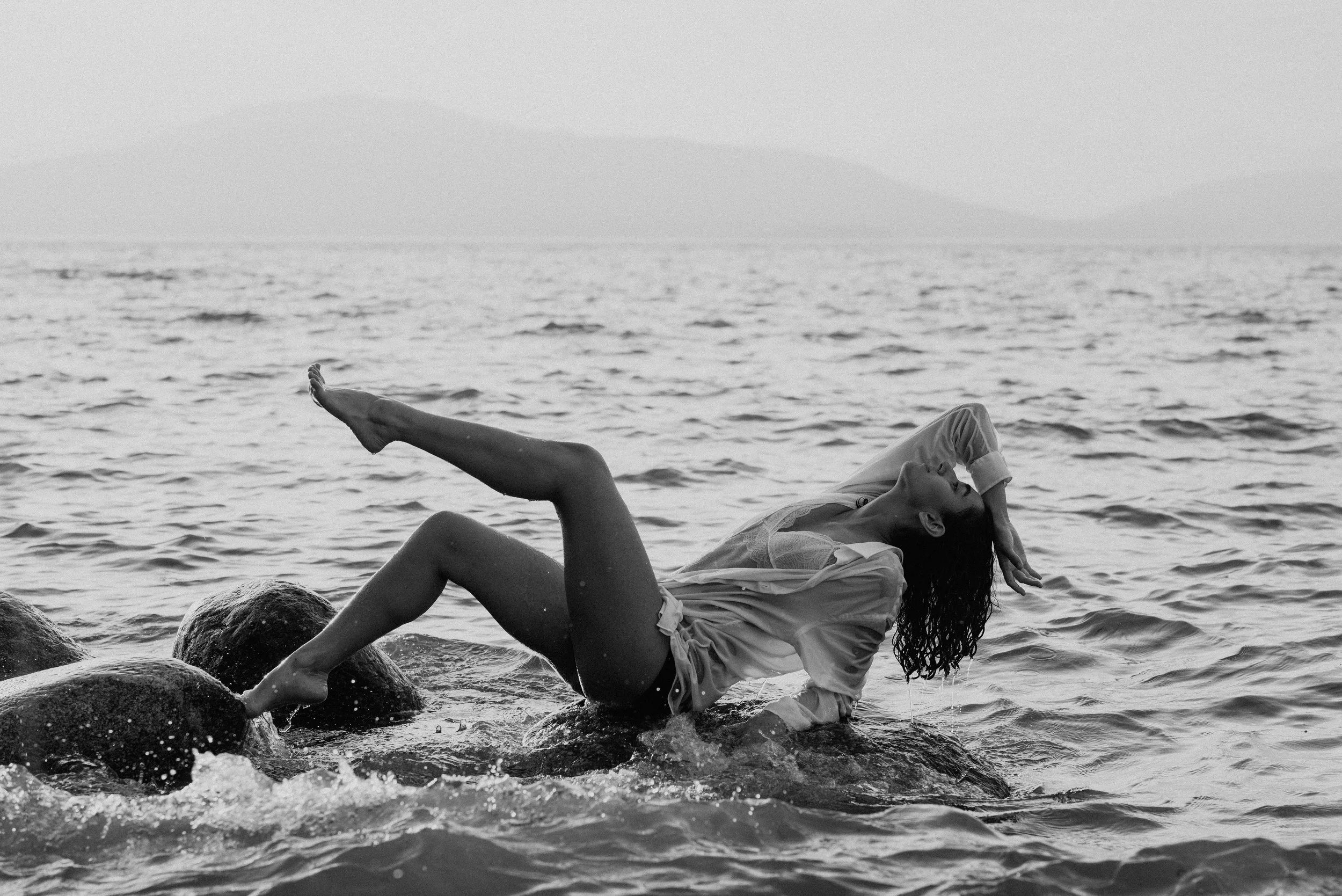 dancer-laying-on-rock-in-ocean.jpg
