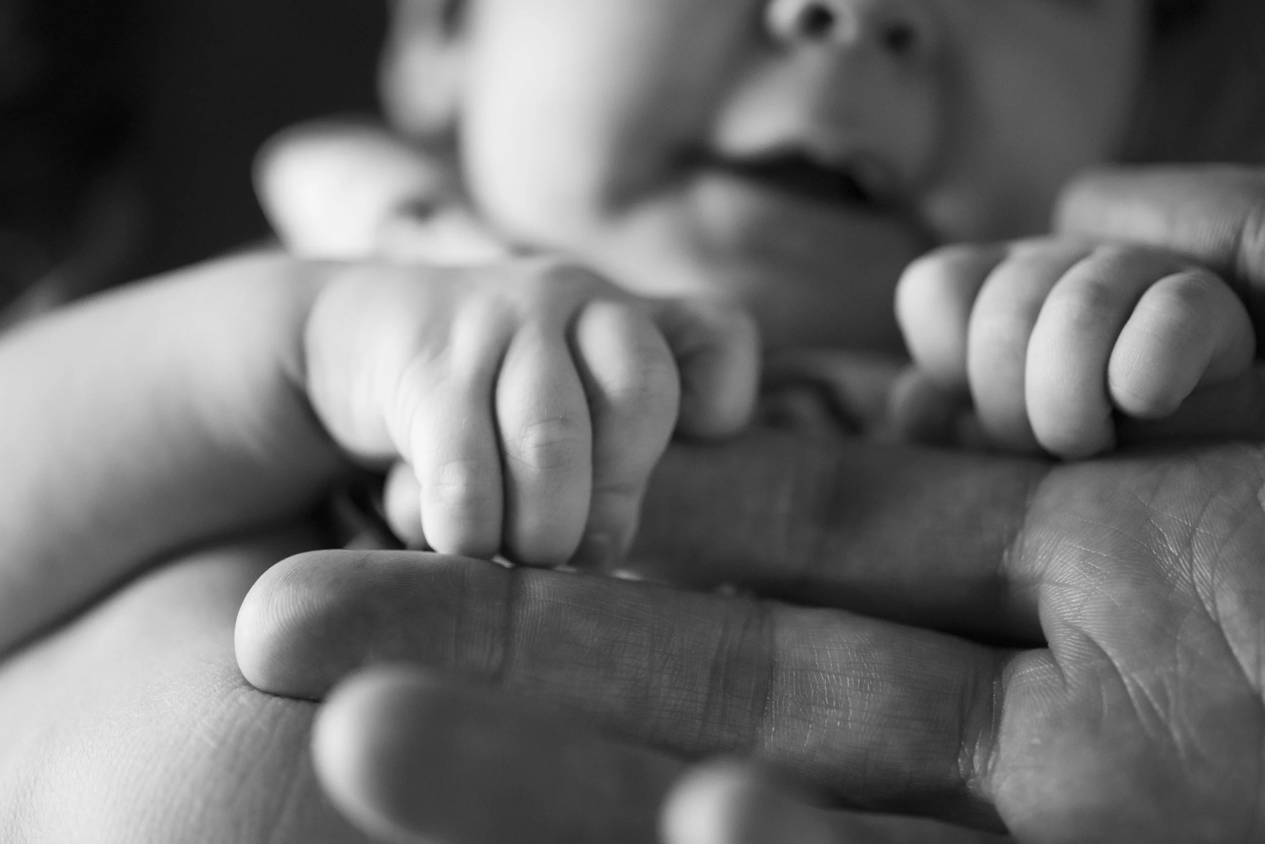 tiny-baby-hands-wrapped-around-dads-hands.jpg