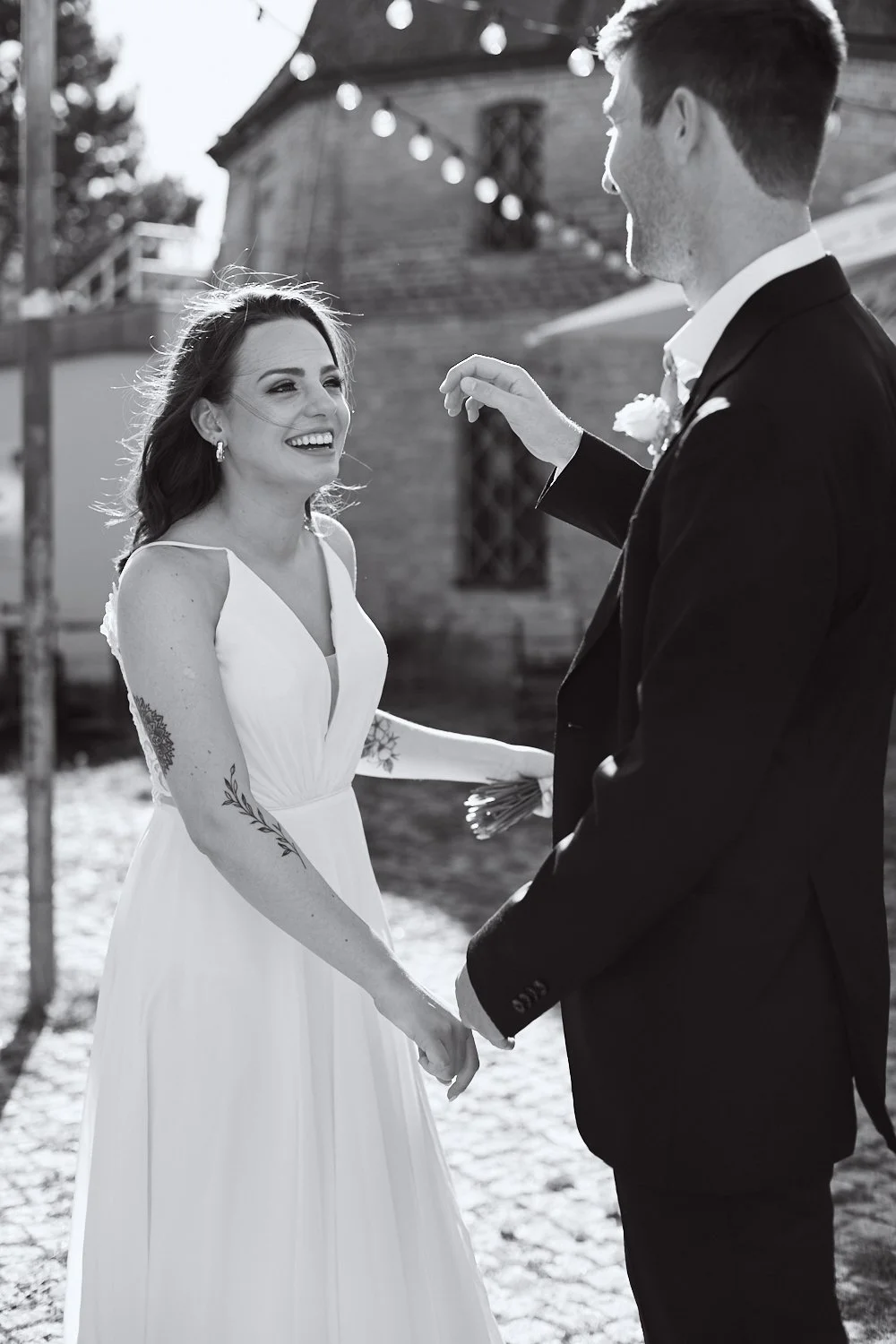 Bride laughing with groom.