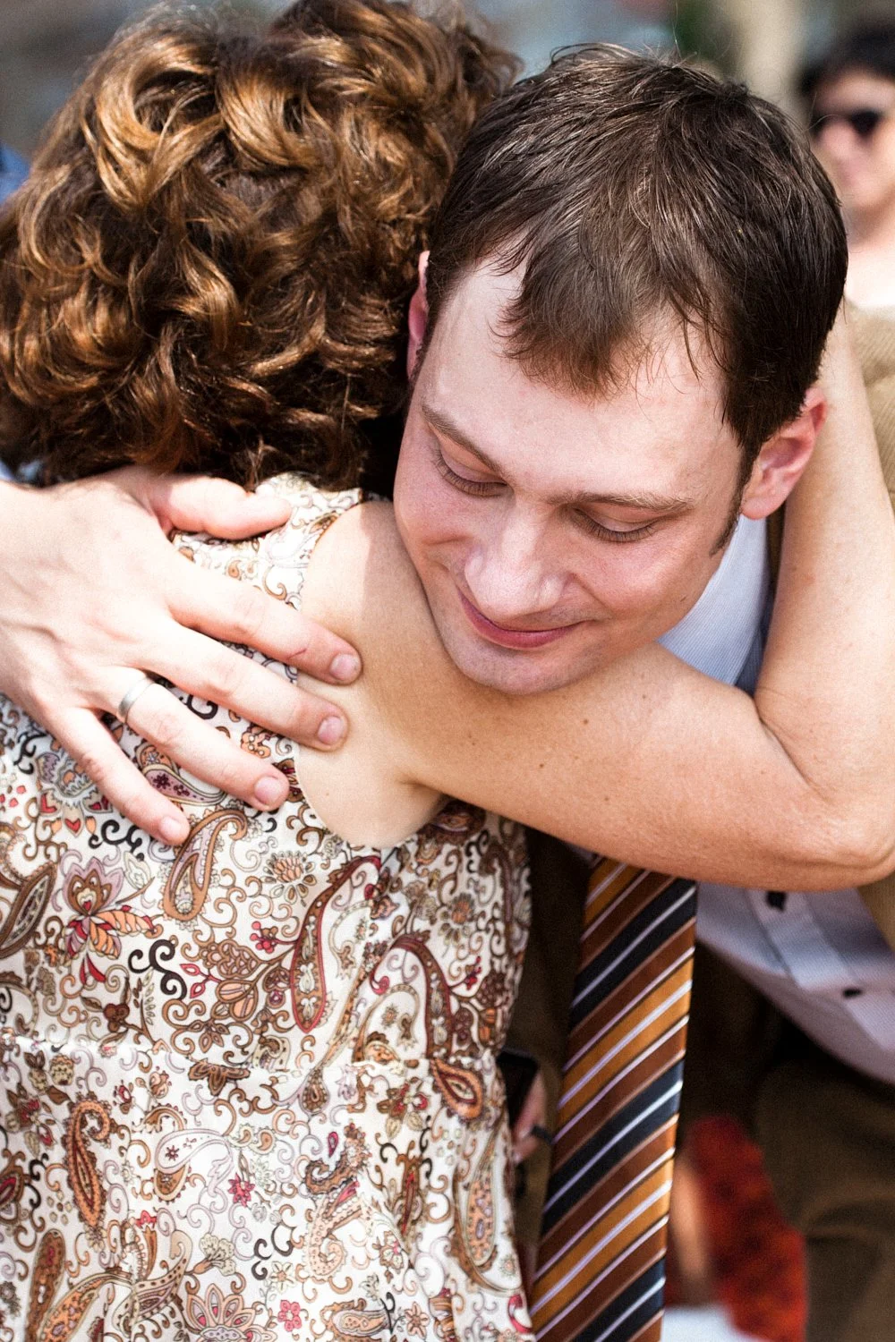 Wedding guest congratulating groom after wedding ceremony.