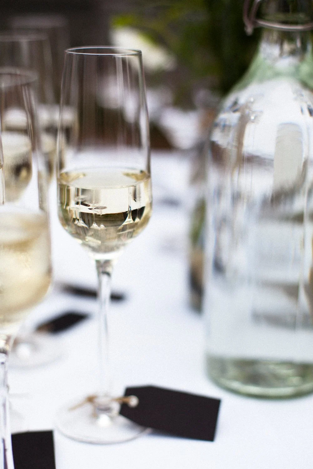 Close up of a champagne glass and bottle.