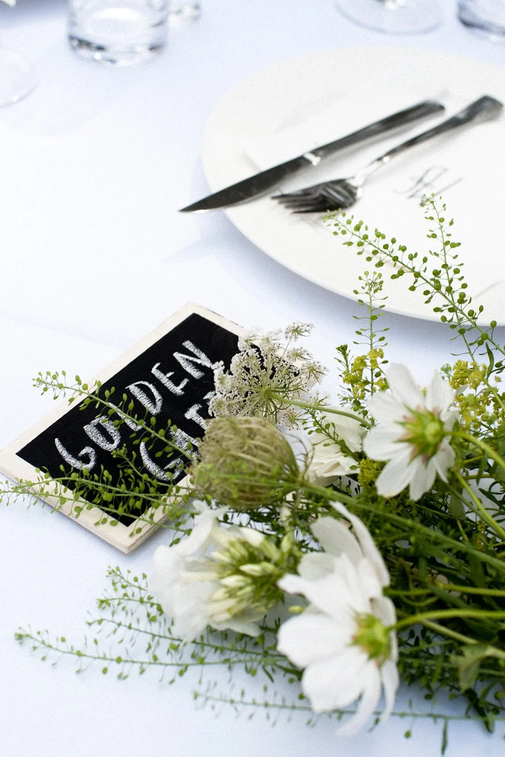 Name tag and flowers on a table.