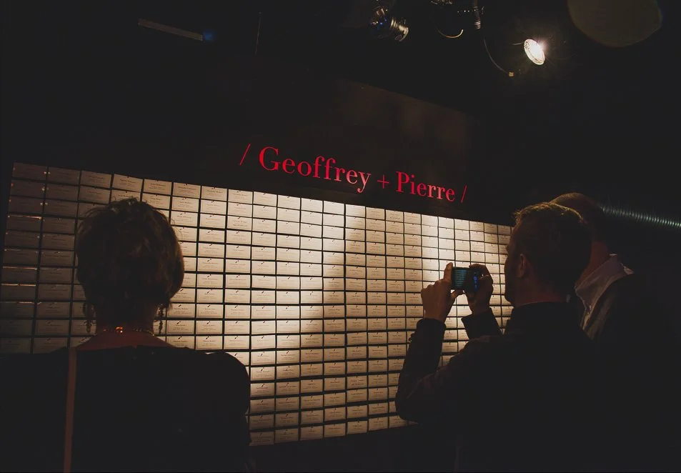 Name tags pinned to a wall for a gay wedding.