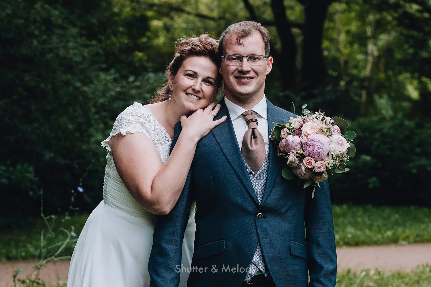 Portrait of the bride and groom in a park.