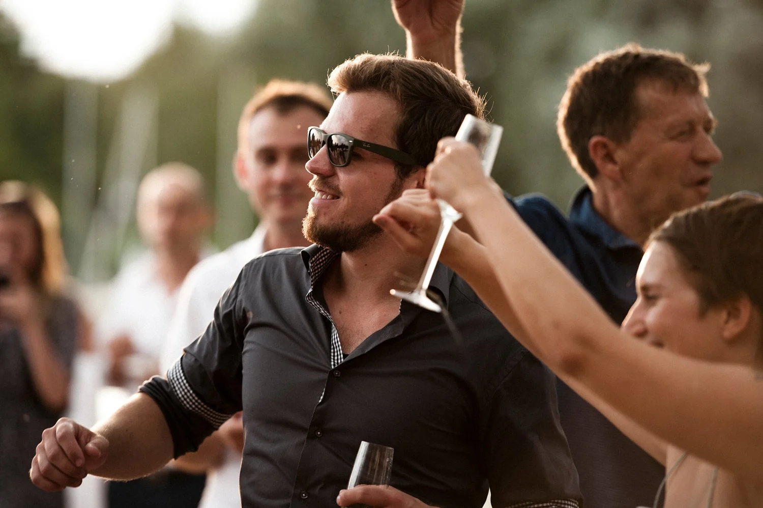 Wedding guest with sun glasses dancing.
