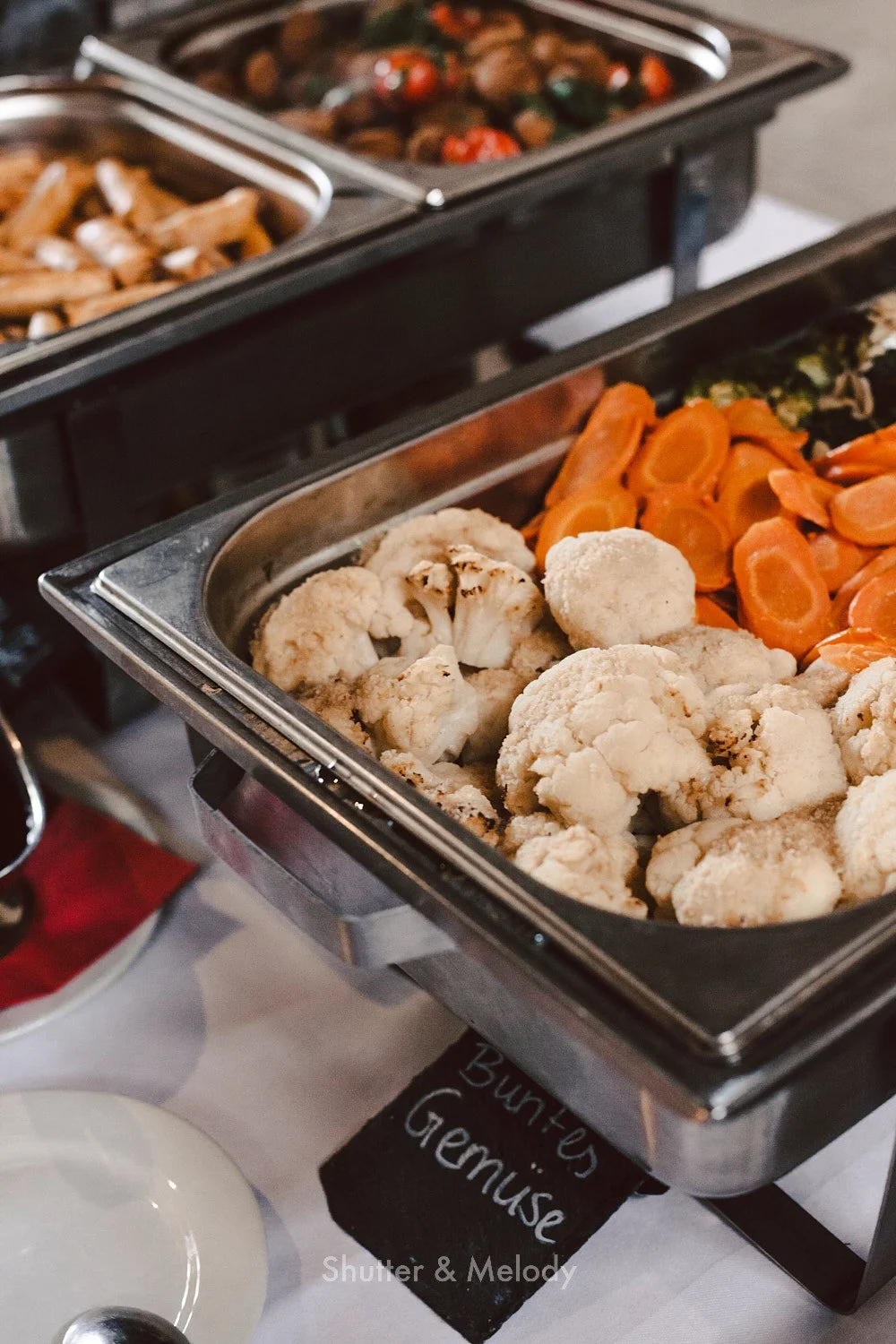 Vegetables in a catering dish served during a buffet.