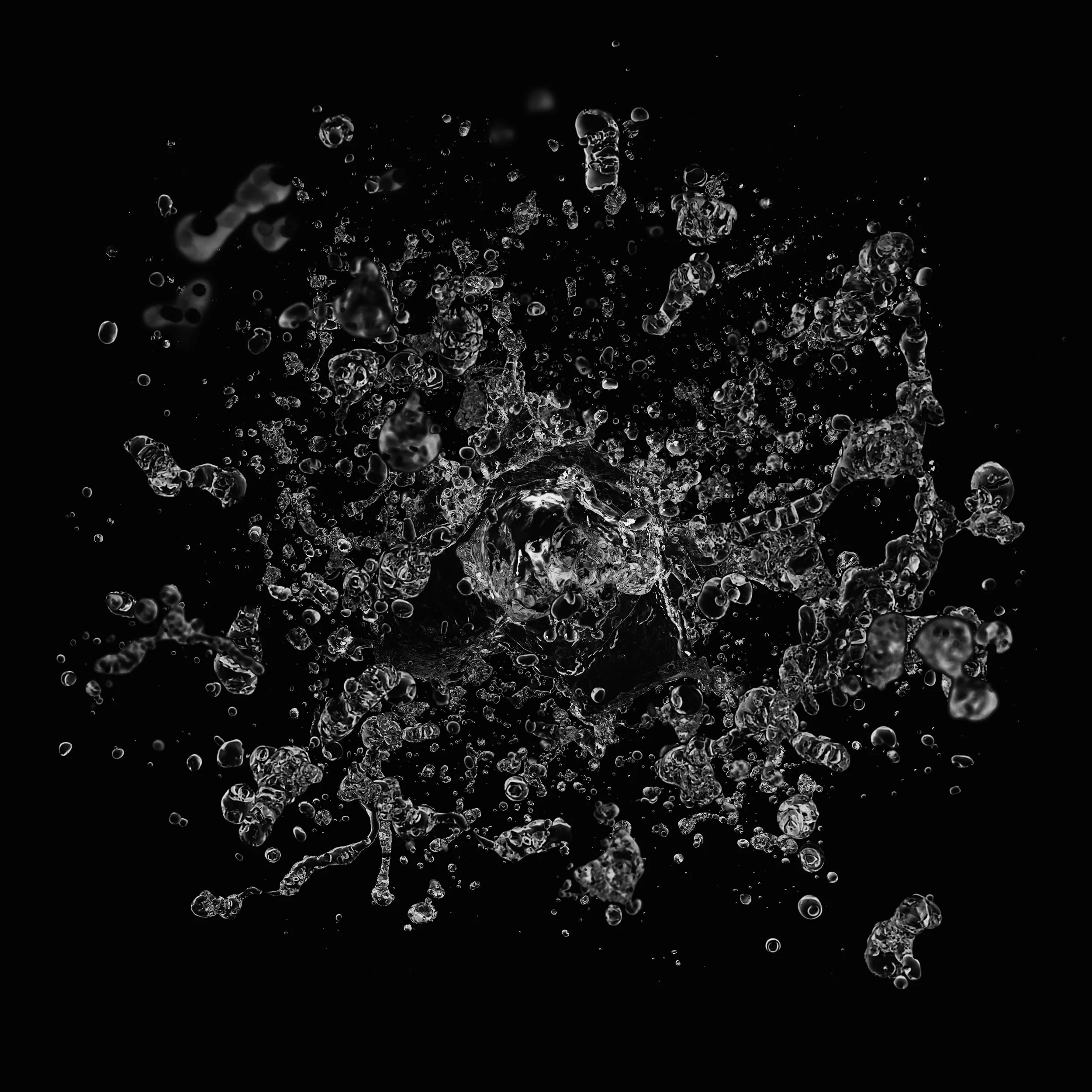 Black and white photo of water splashing against a black background.