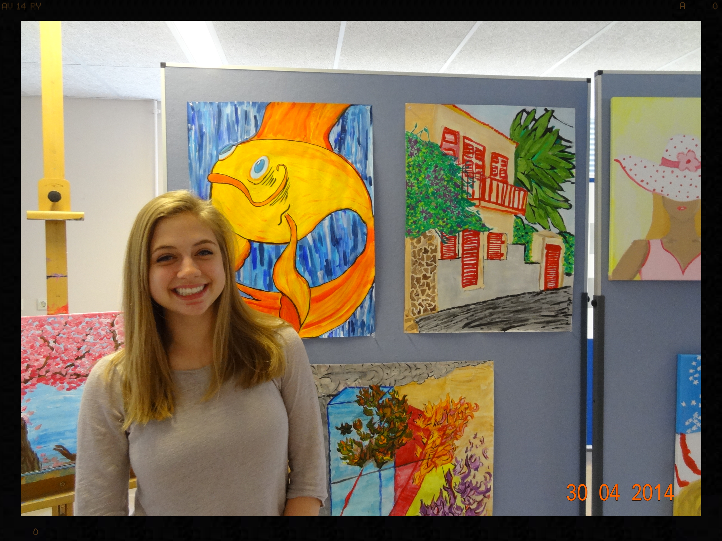 My daughter in front of some of her art.