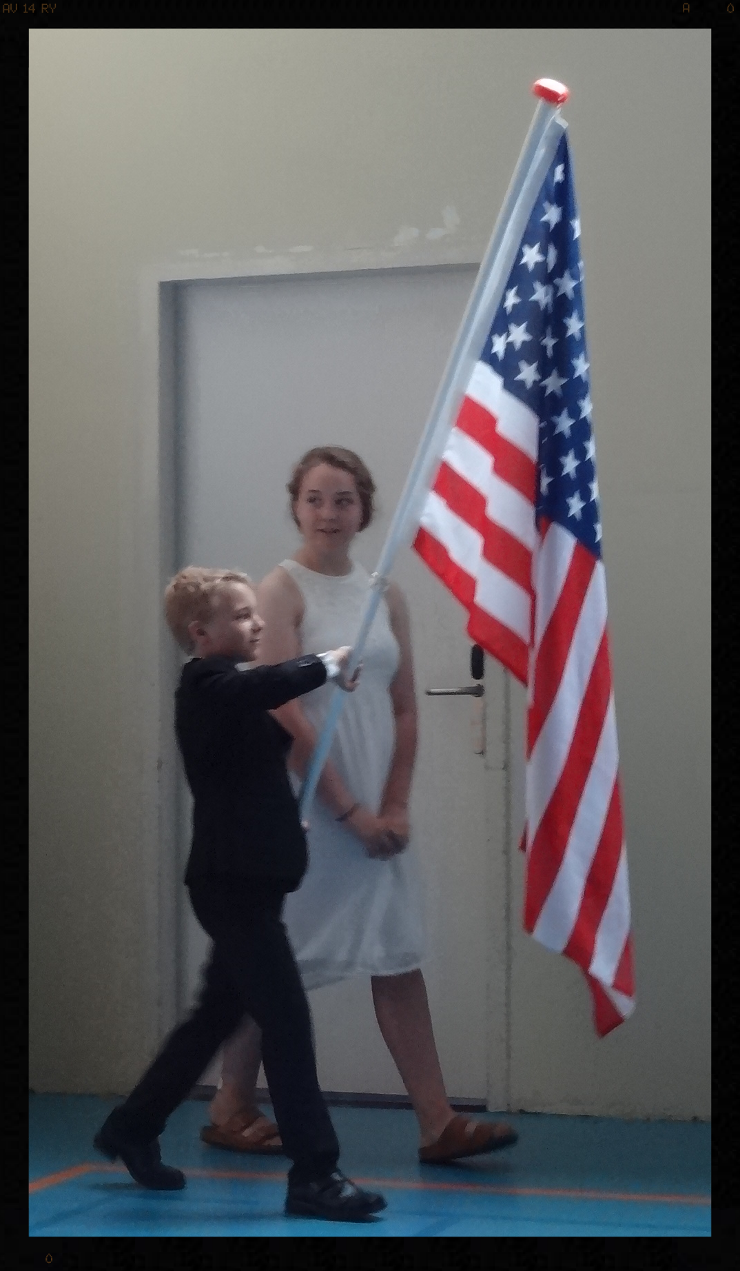 Our youngest carrying the flag for his graduating teenage siblings.
