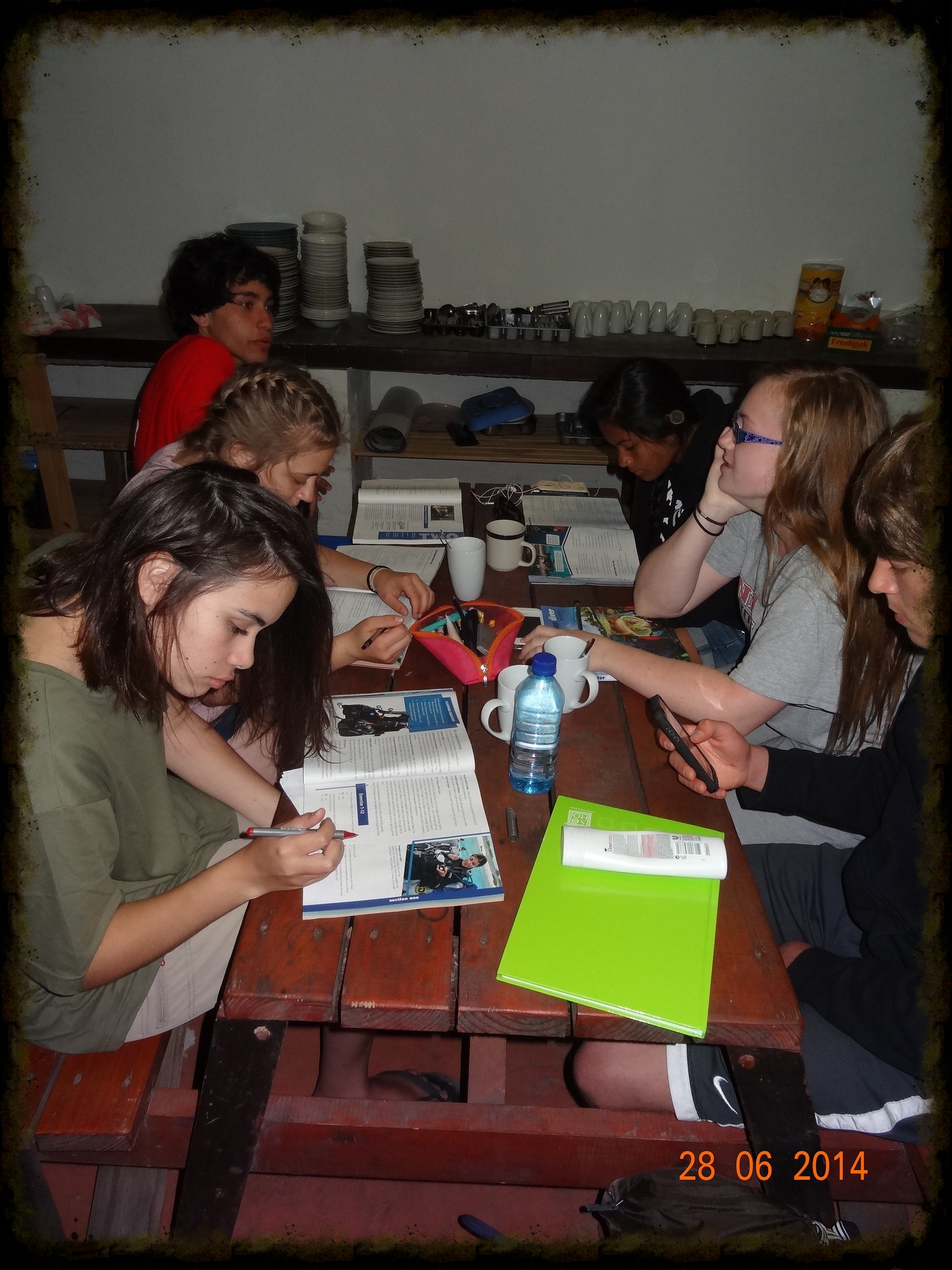 Students studying from their dive manuals in the mess hall, even though there will be no grade assigned to the HW.