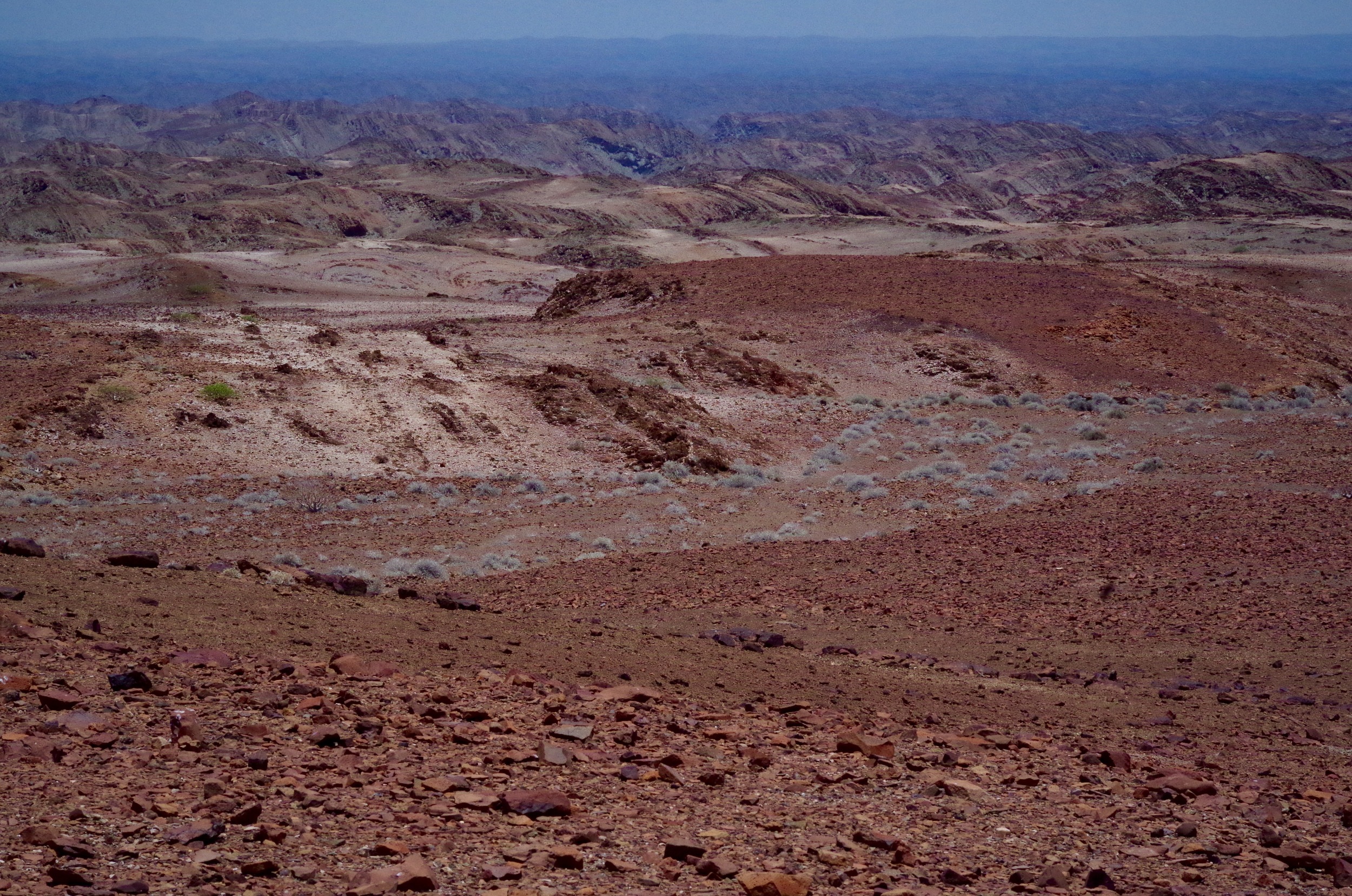 Red Hills Iron-rich rock formations rise out of the scorched landscape, spreading as far and wide as the deep blue of the desert’s horizon.