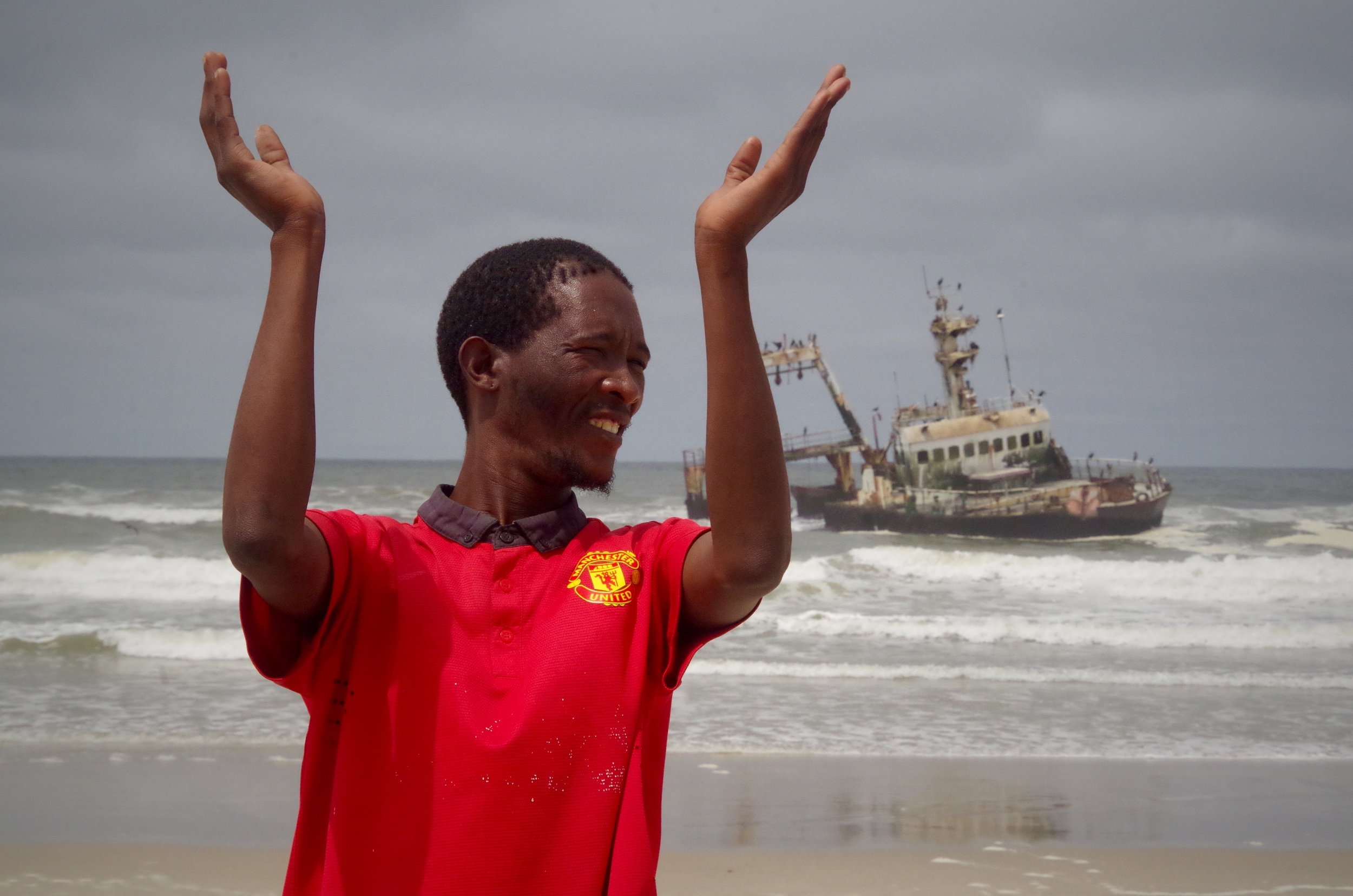 Hallelujah Roy, a Manchester United fan praises the Lord for this seagull-clad ship, beached off the skeleton coast.
